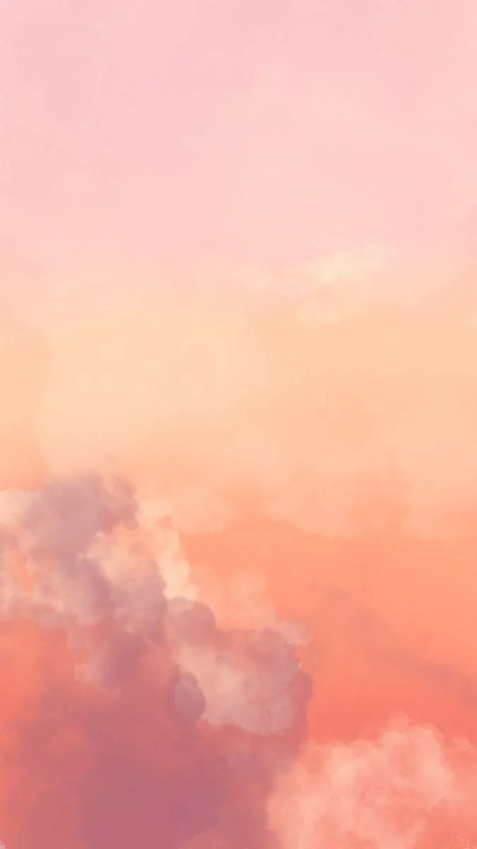 Pink and orange clouds in the sky at sunset or sunrise.