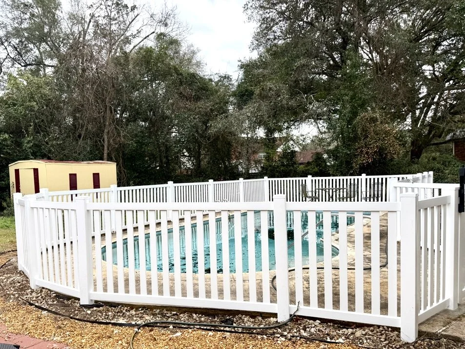 white vinyl picket pool code fence with 5" posts in concrete on 8' centers.