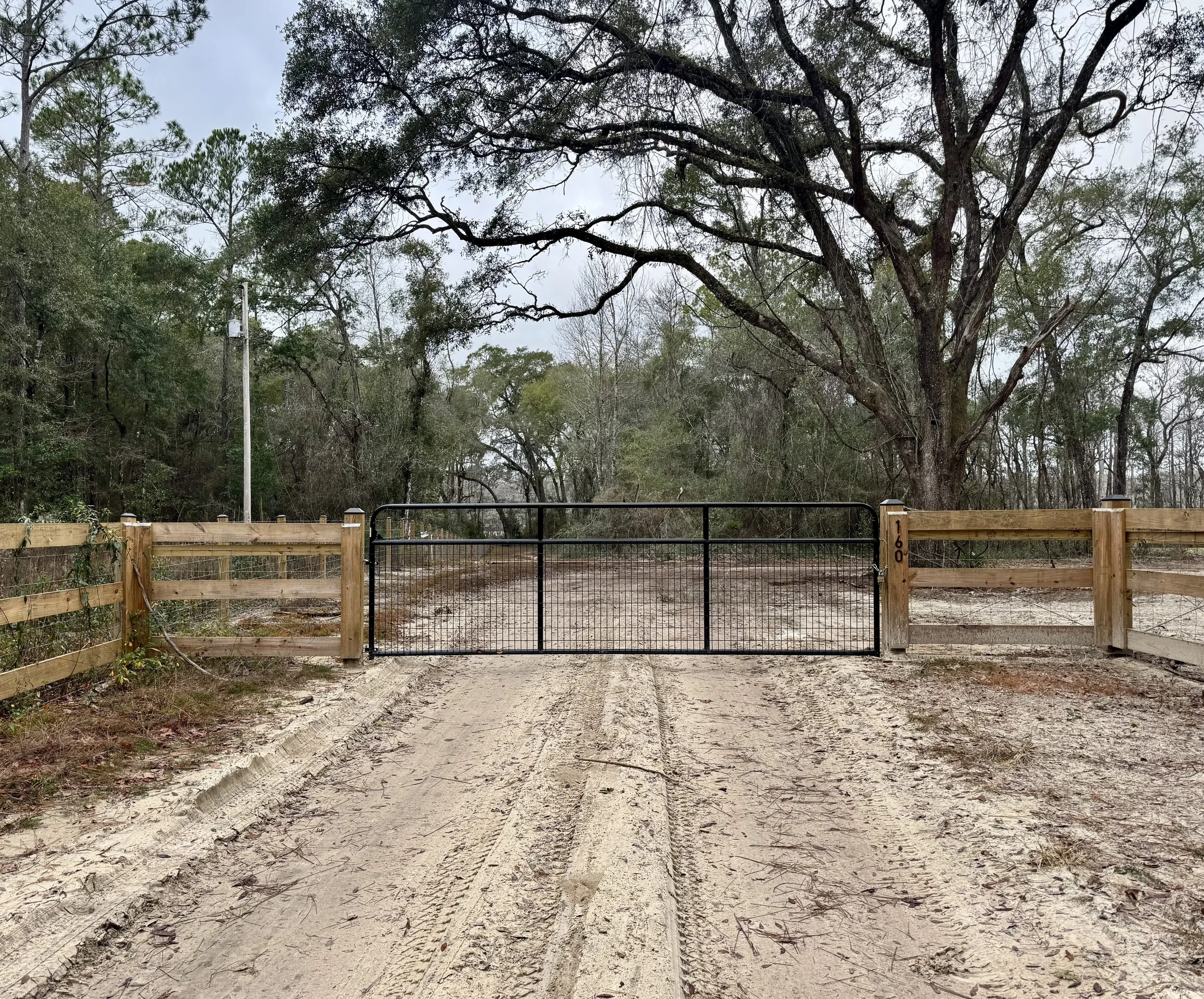 Ranch style fence with field wire and gate.