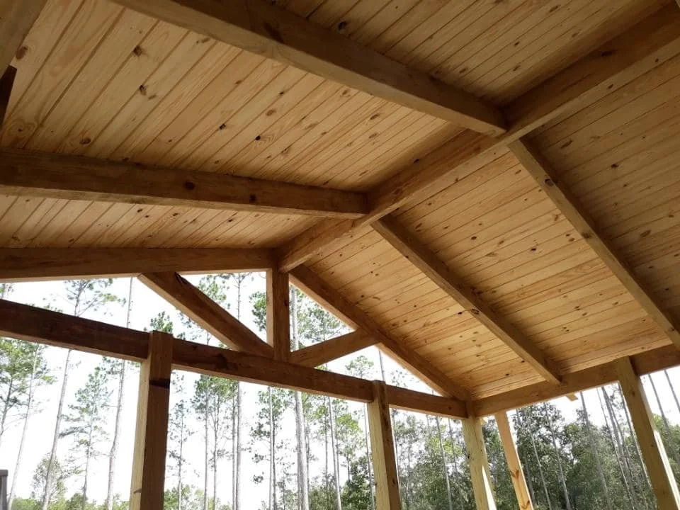 Wooden ceiling with support beams of a newly installed deck.