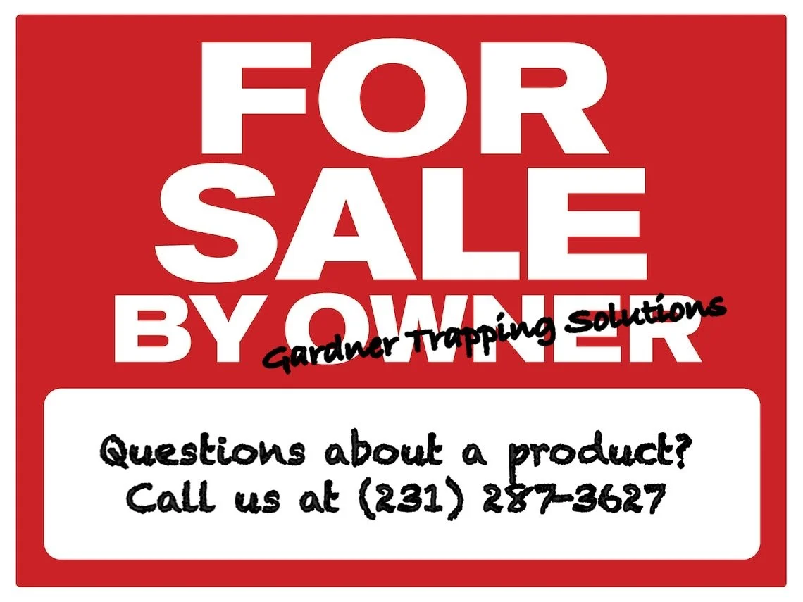 A red and white sign indicating items are for sale by Gardner Trapping Solutions, with a phone number for questions.