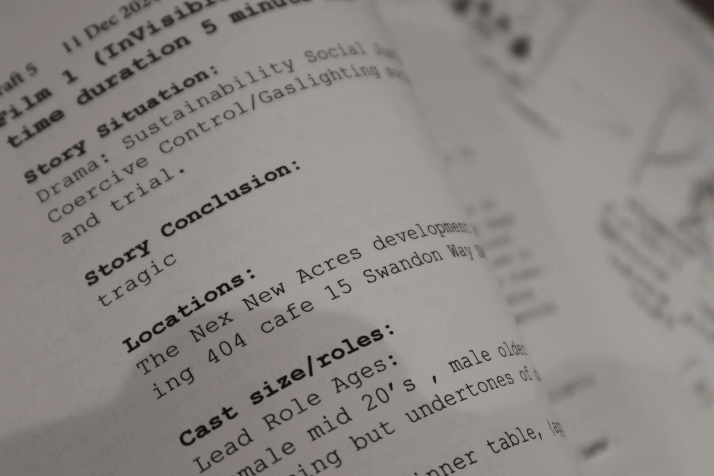 Close-up of a printed script page with bolded sections, showing parts of a story titled "story conclusion" and details about locations and cast roles.