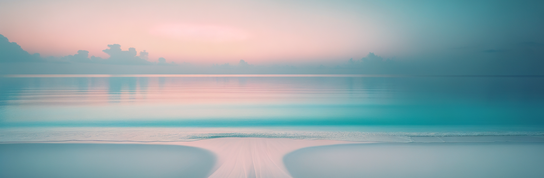 A tranquil beach scene with calm turquoise waters, pink and purple sky at sunset, and a sandy shoreline with gentle waves.