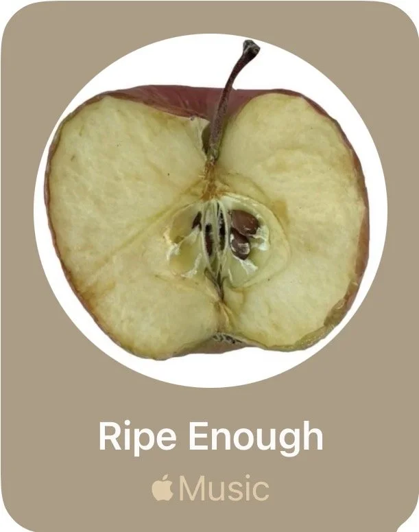 A close-up of a ripe apple that's been sliced in half, revealing its seeds and core, on a beige background with the text 'Ripe Enough' and the Apple Music logo.