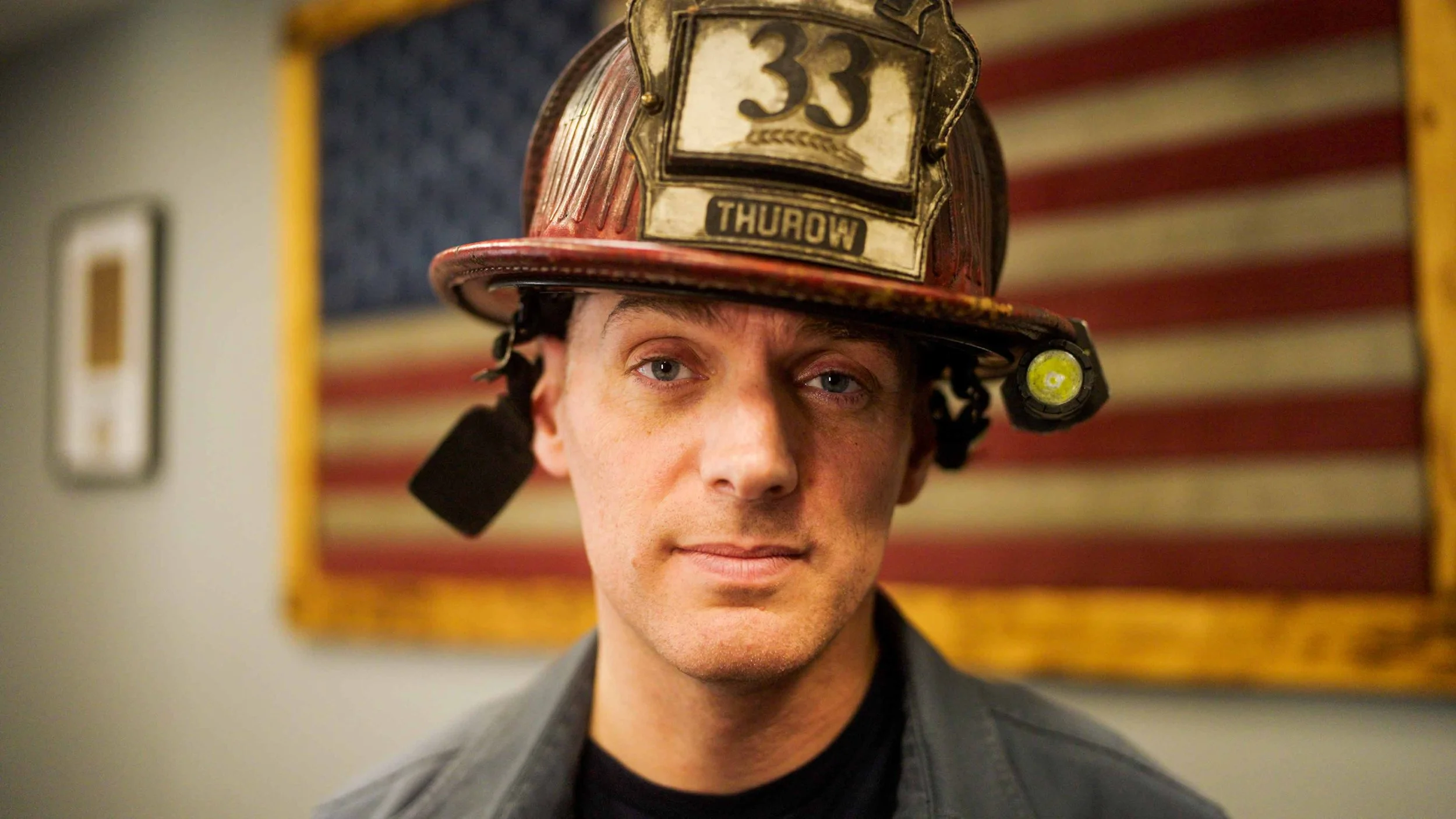 A portrait of Mike Thurow, Independent candidate for Wisconsin's Sixth Congressional District, in his fire helmet.