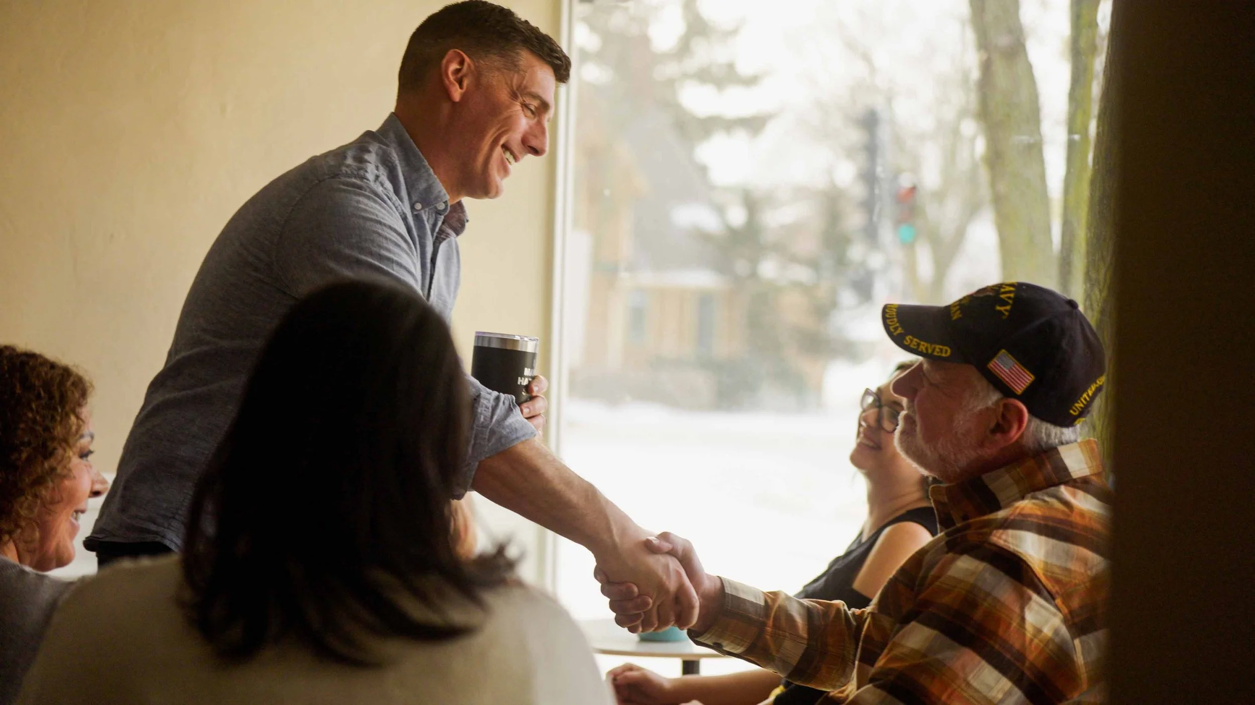 A portrait of Mike Thurow, Independent candidate for Wisconsin's Sixth Congressional District, shaking hands with a constituent.