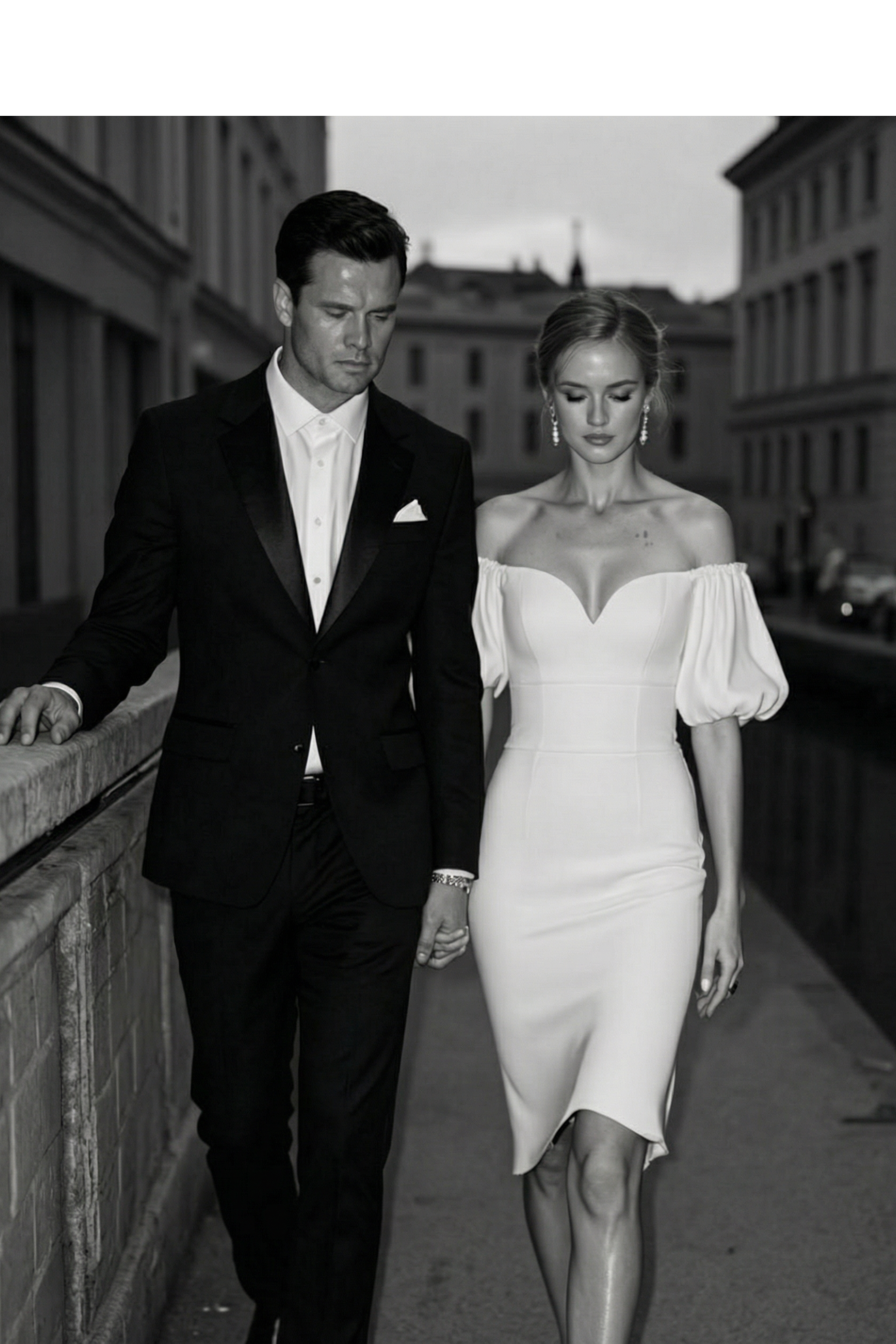 A black and white photo of a man and woman walking hand in hand along a city street, dressed in formal attire, with buildings in the background.