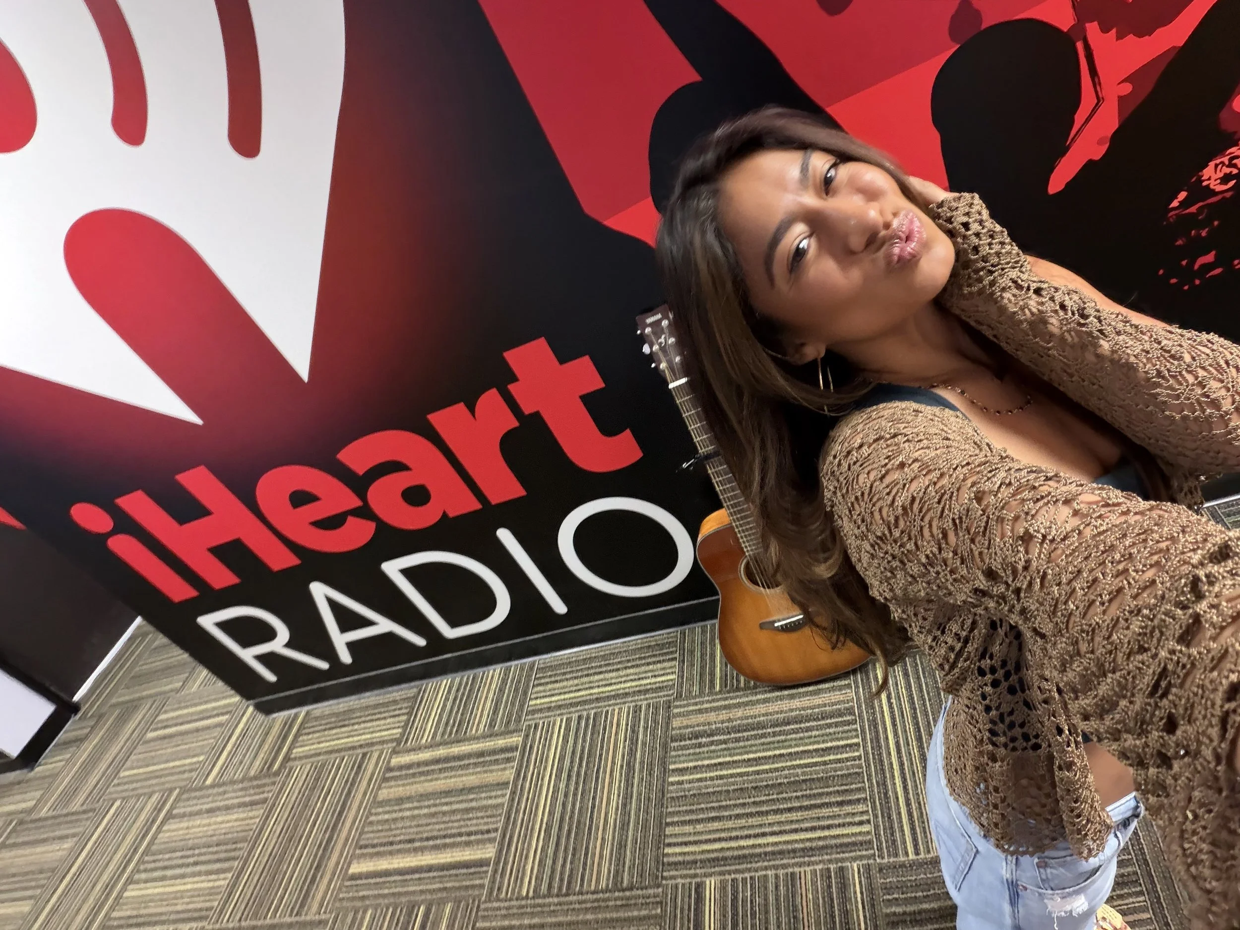 A woman taking a selfie at iHeartRadio after performing on island 98.5 iHeartRadio's wild wahine segment. Wake Up Crew interviewed her for an hour. She sang 3 original songs and 1 cover song on air.