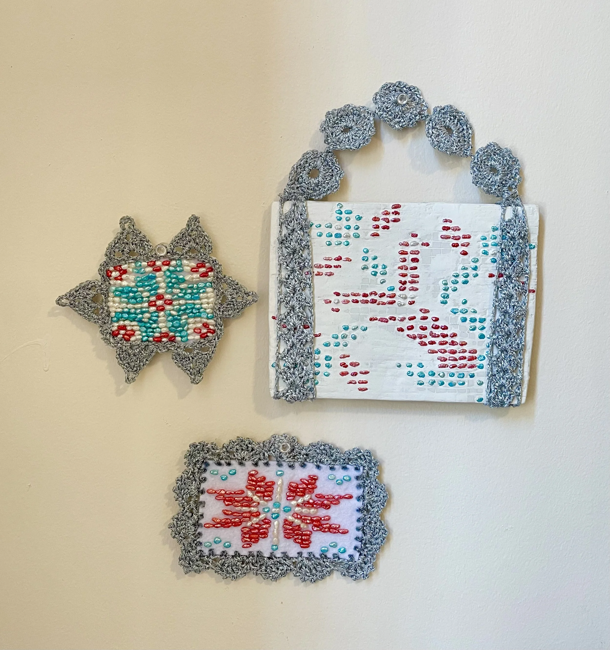 Snowflakes (2026). Clay, pearl beads, felt, and polyester yarn. 