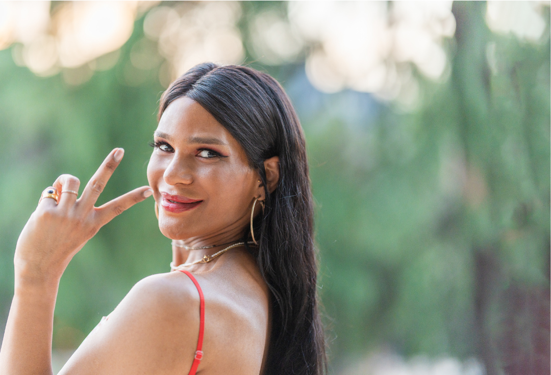 trans woman smiling. pelvic floor therapy for vaginoplasty. gender affirming pelvic floor pt, non-binary safe pelvic floor provider, LGBTQIA  healthcare, bottom surgery rehab, phalloplasty recovery, post-op gender affirming surgery