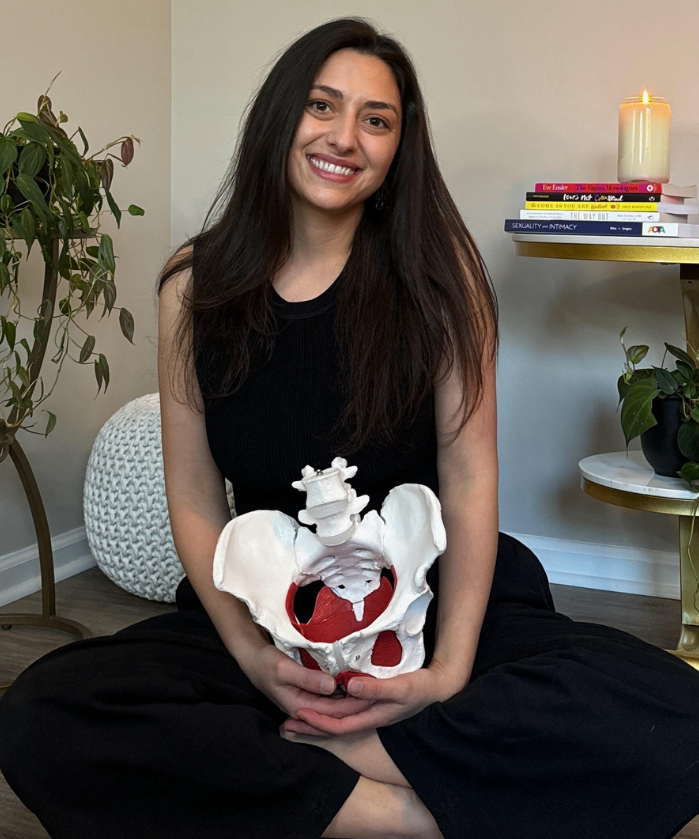 gina holding a pelvic floor model- a pelvic floor therapist in denver and for virtual pelvic floor therapy, she's a pelvic floor occupational therapist, specializes in working with trauma and sexual health concerns, & has a pelvic sex counseling cert