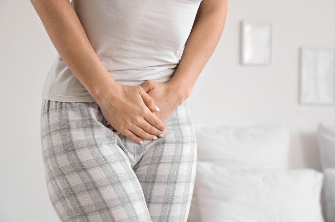 woman holding bladder due to urgency to pee. treatment for urinary urgency in Denver, CO
