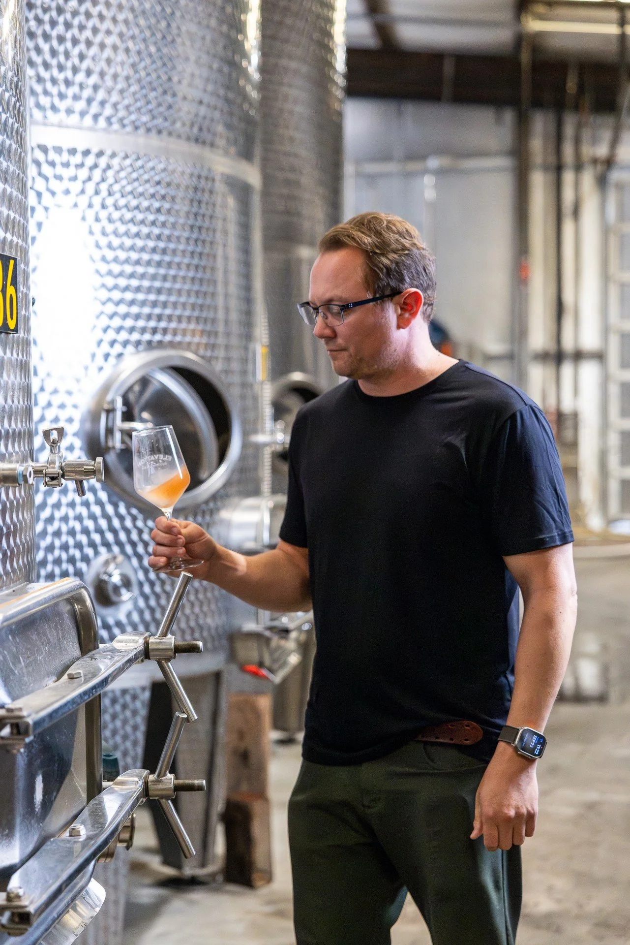 Hill & Harbor winemaker checking a wine tank in the cellar