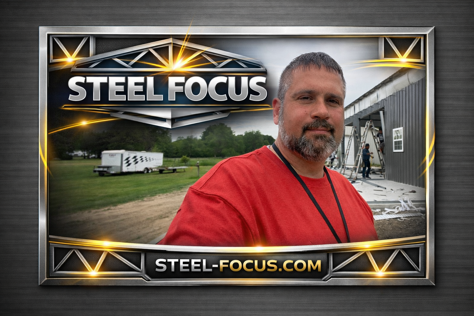 A man with a beard and short hair taking a selfie in front of a building under construction, with a sign in the foreground that reads 'STEEL FOCUS' and the website 'STEEL-FOCUS.COM'; construction workers and a trailer are visible in the background.