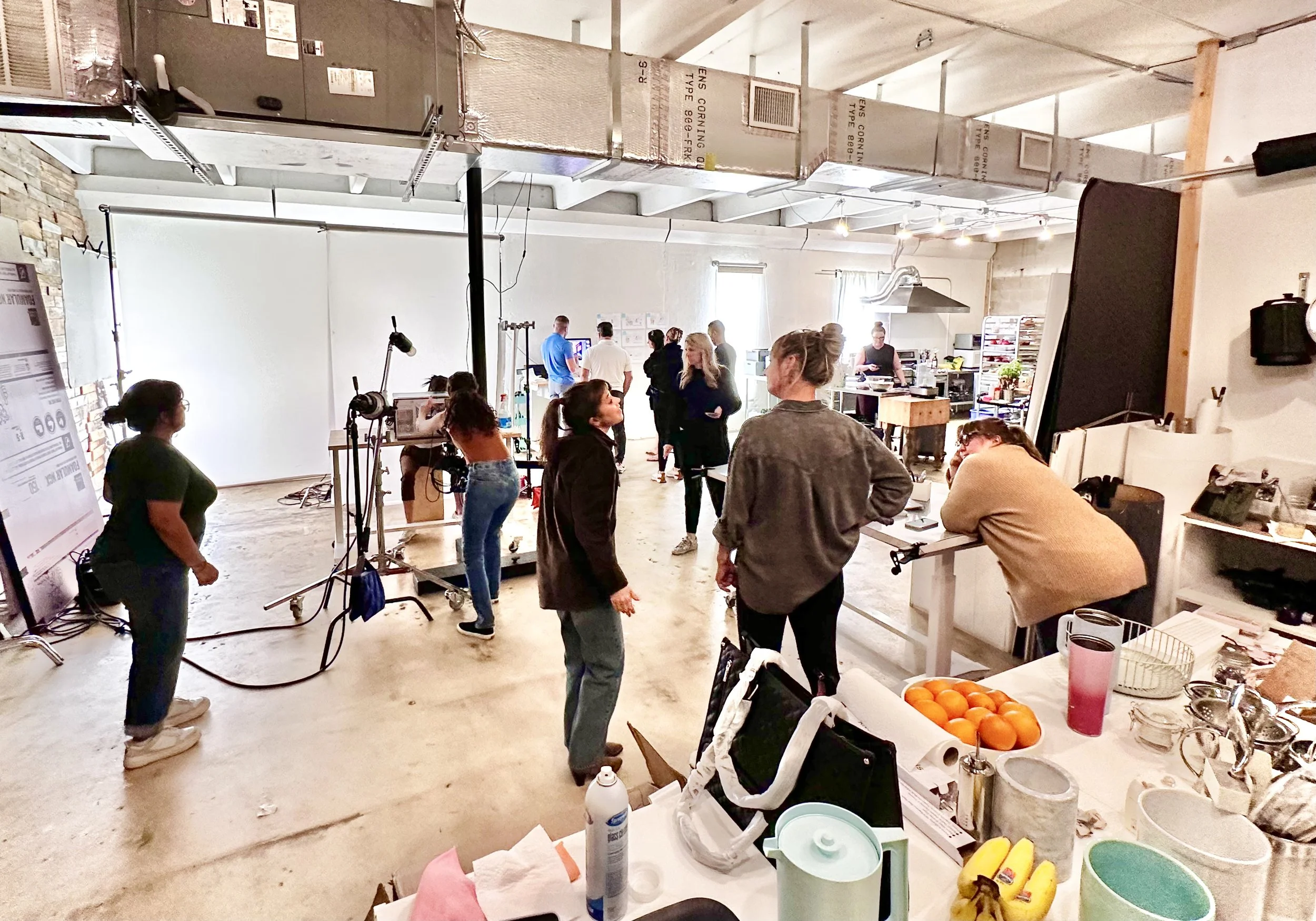 Behind the scenes image of a large crew of a commercial food photography photoshoot.