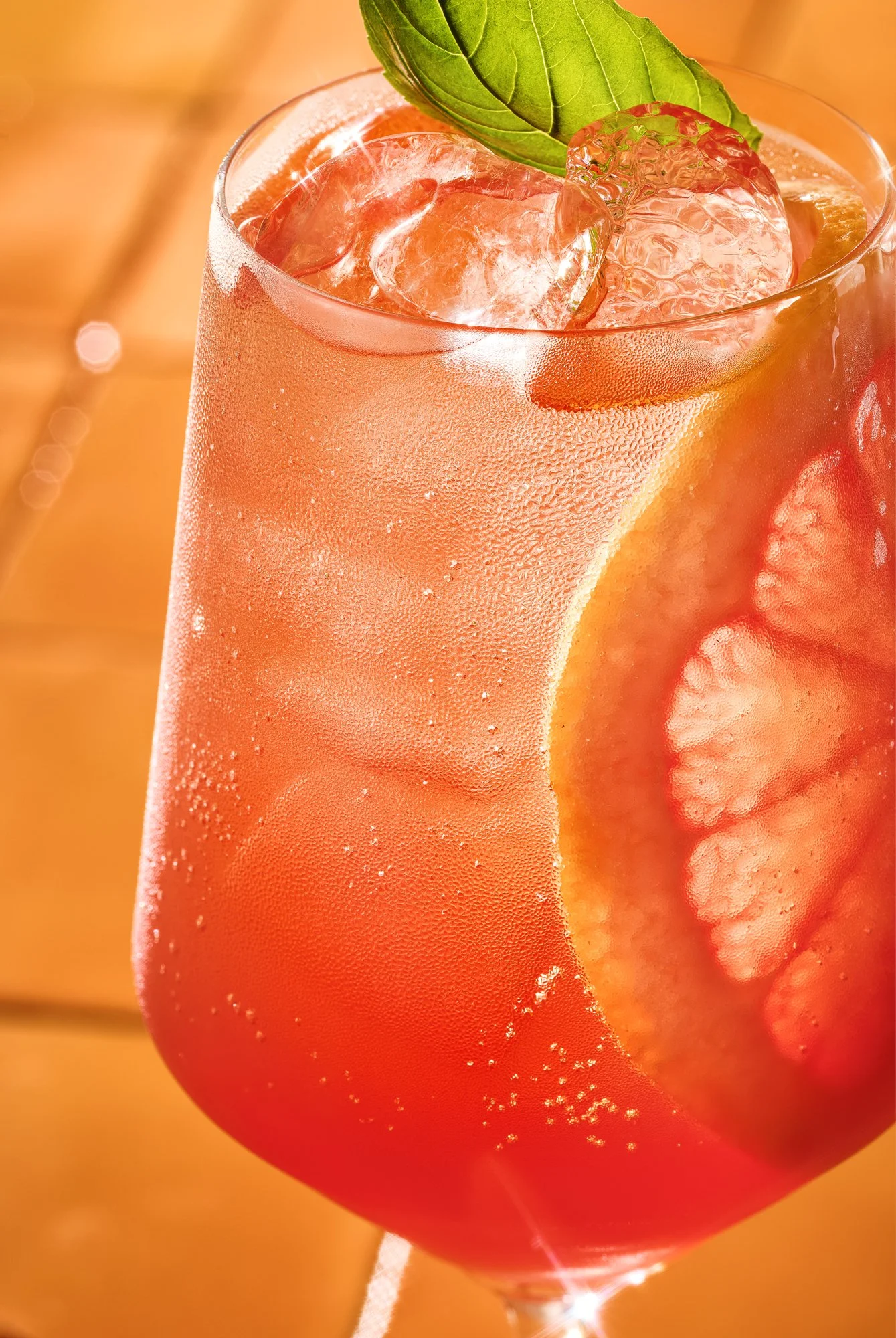 Close up beverage photography of a refreshing orange cocktail with grapefruit