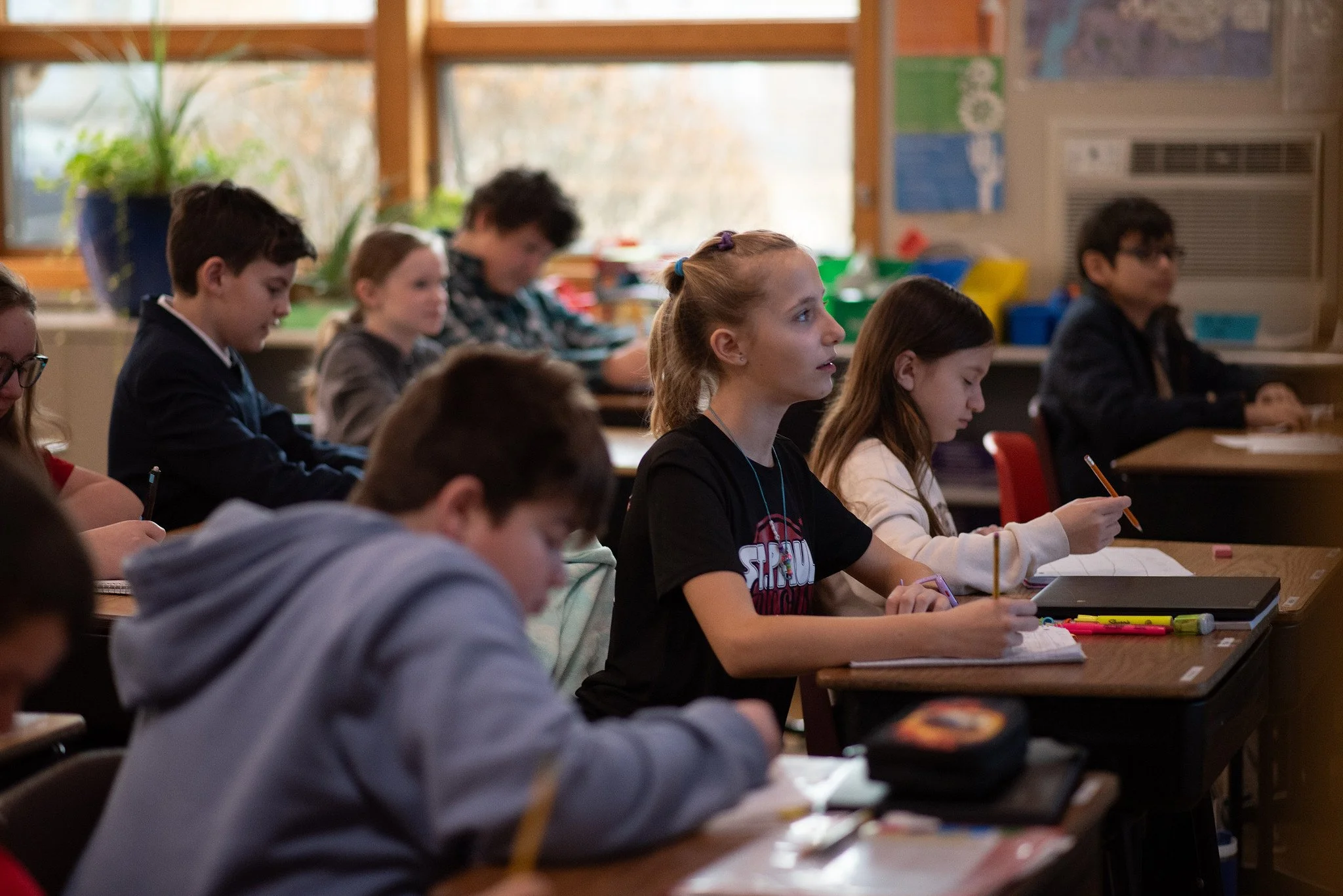 Students sitting at desks in a classroom during lesson
