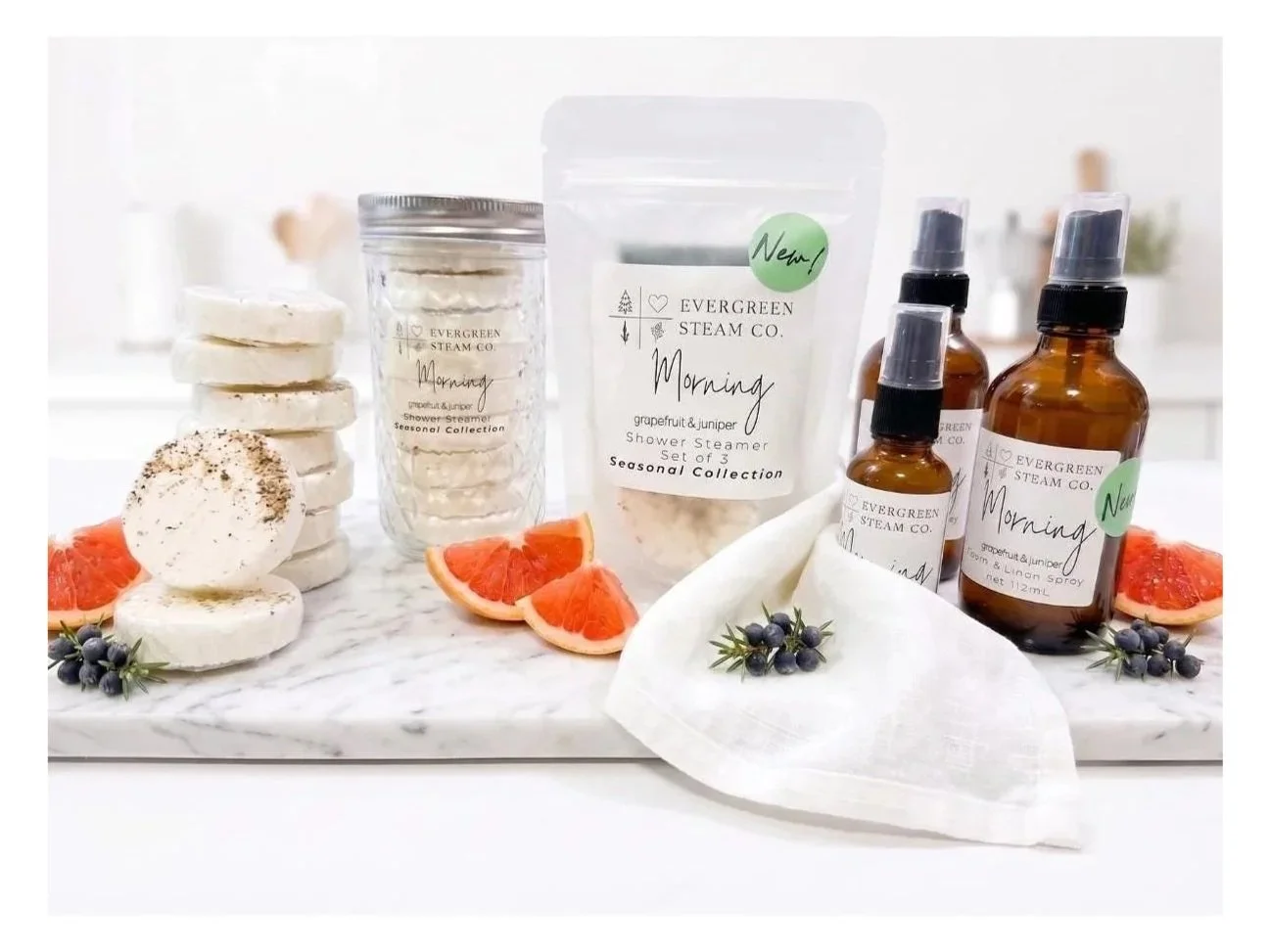 Evergreen Steam Co. Morning seasonal collection featuring shower steamers and room & linen spray with grapefruit, juniper and botanical ingredients.