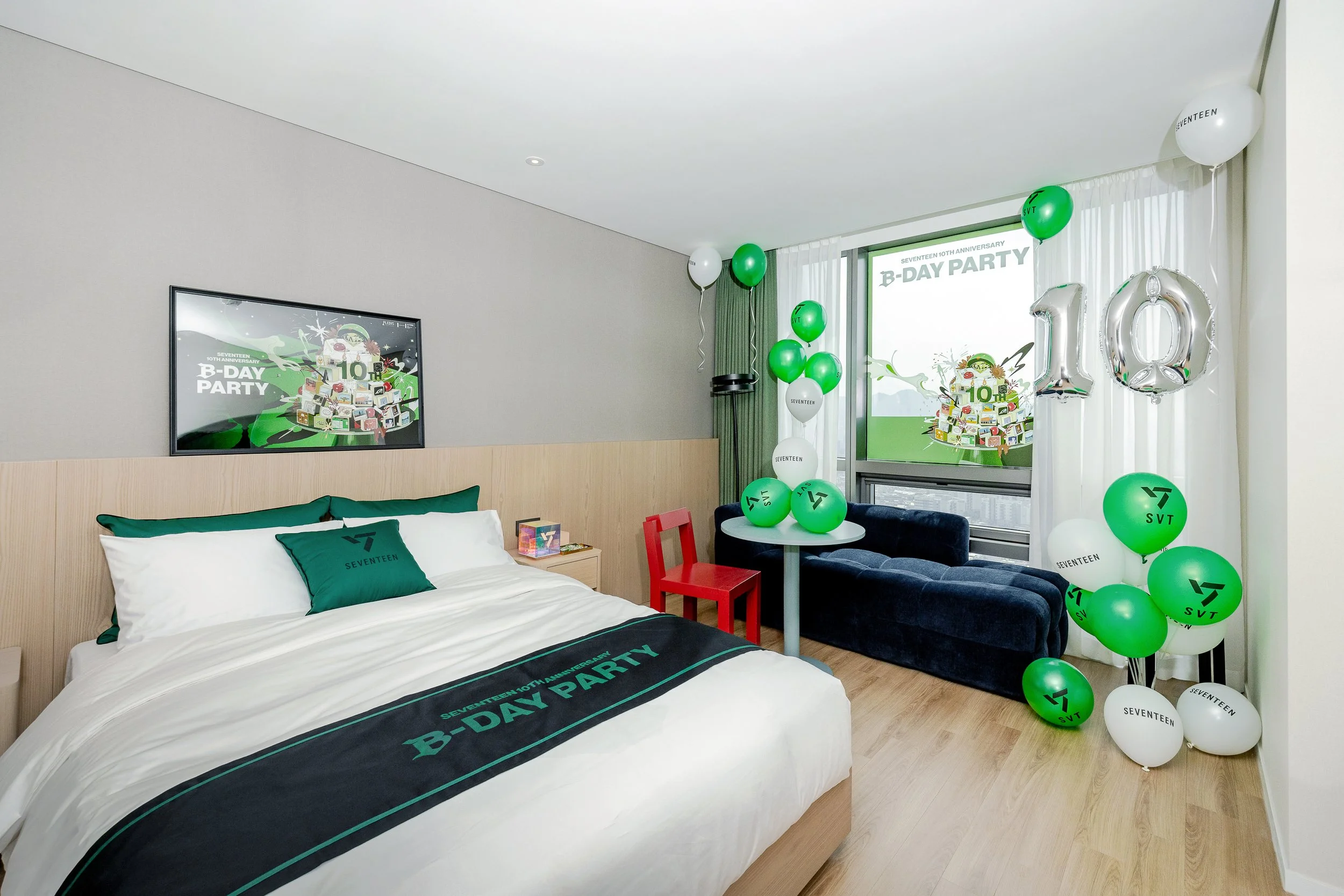 Hotel room decorated for Seventeen's 10th anniversary with balloons, a banner, and themed bedding.