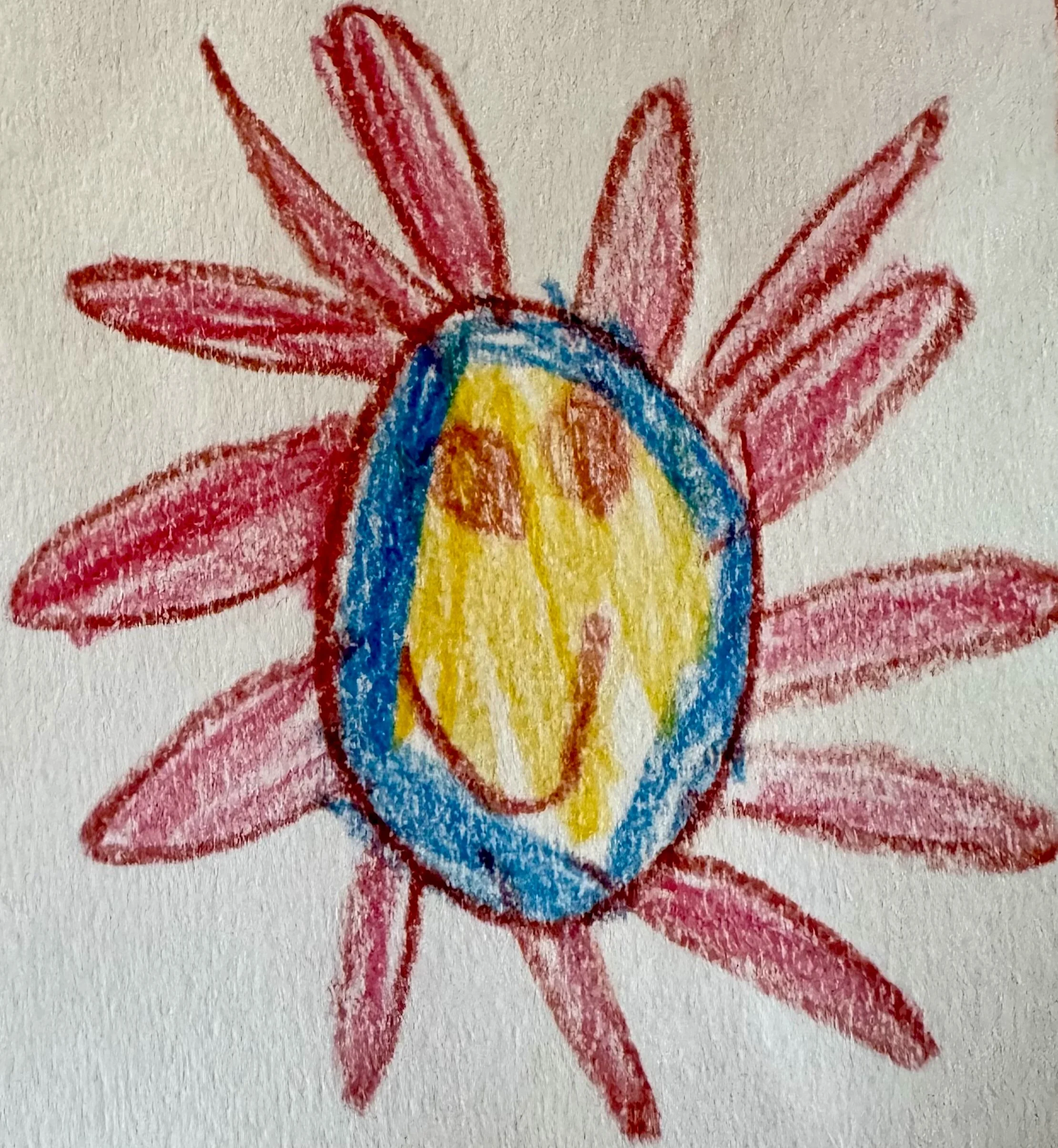 Crayon drawing of a colorful flower with pink petals, a blue center, and yellow and orange details in the middle.