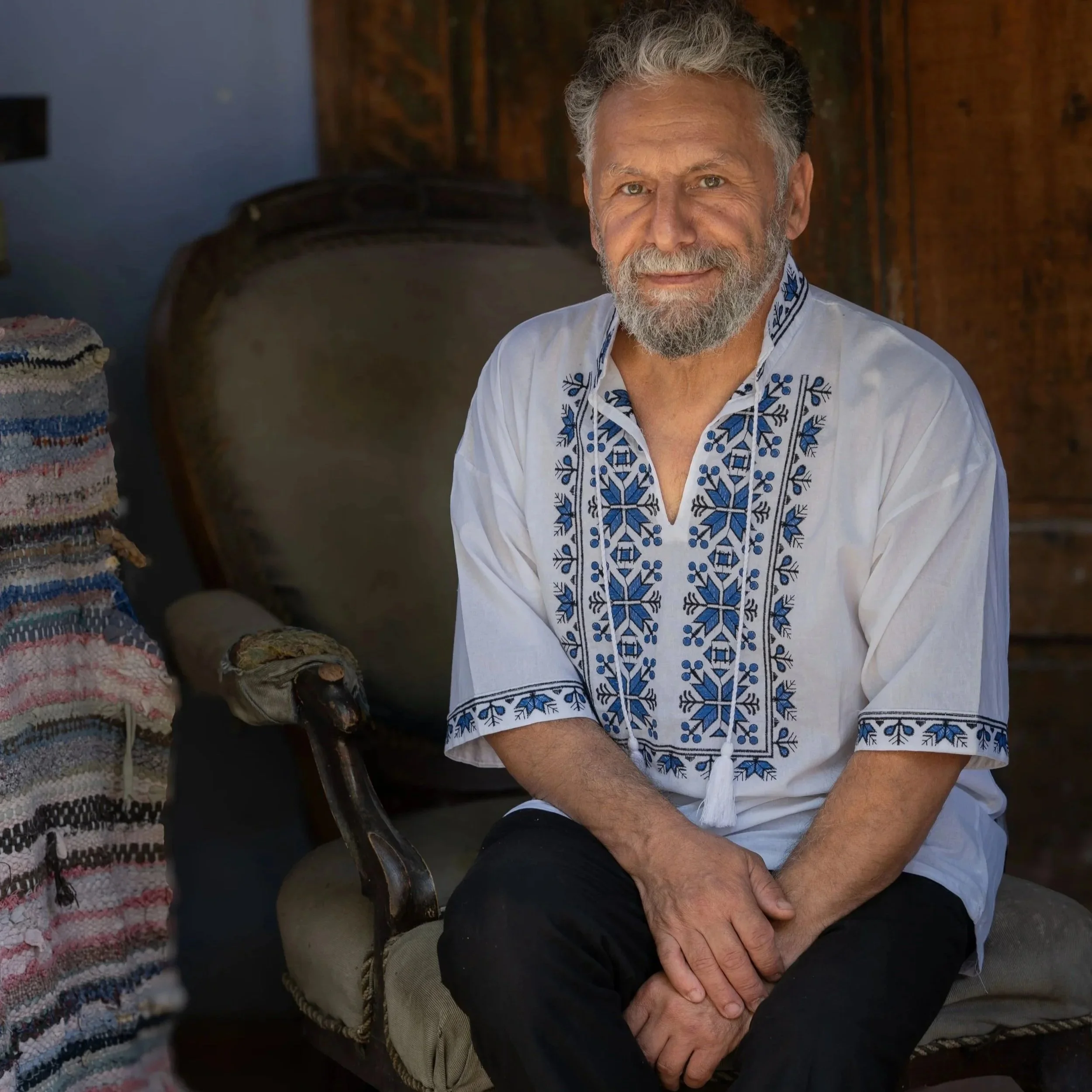 This man was working in his field in Copsa Mare, when three of us walked past carrying our cameras. He hurried home, dressed in traditional clothing, and offered us cold drinks and shade in his yard on a very hot day in rural Romania.