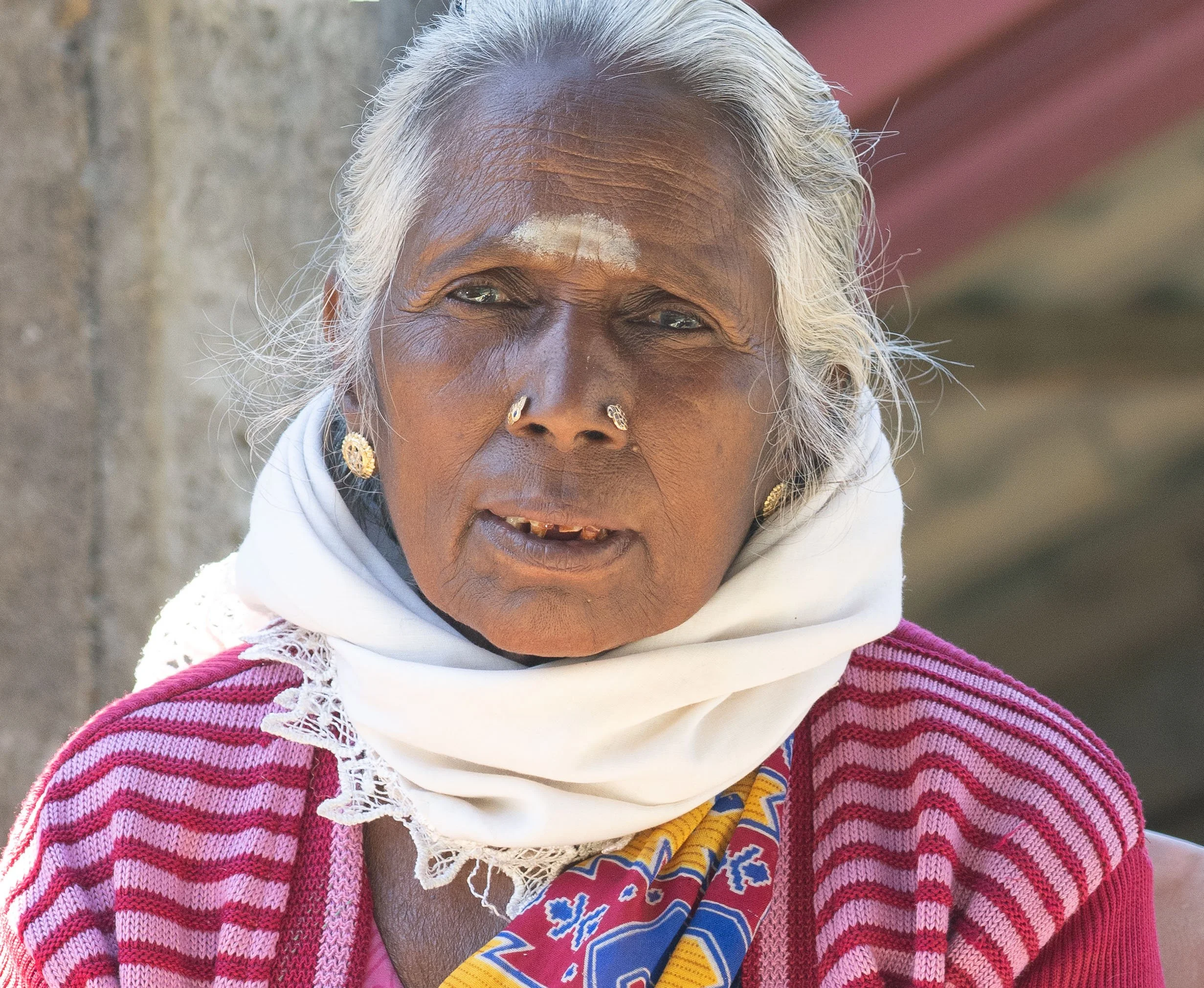 This woman is culturally Tamal, who live in the north and east area of Sri Lanka. The white mark is made of Sandalwood; applying it is believed to retain energy, improve focus, and awaken spiritual intuition.