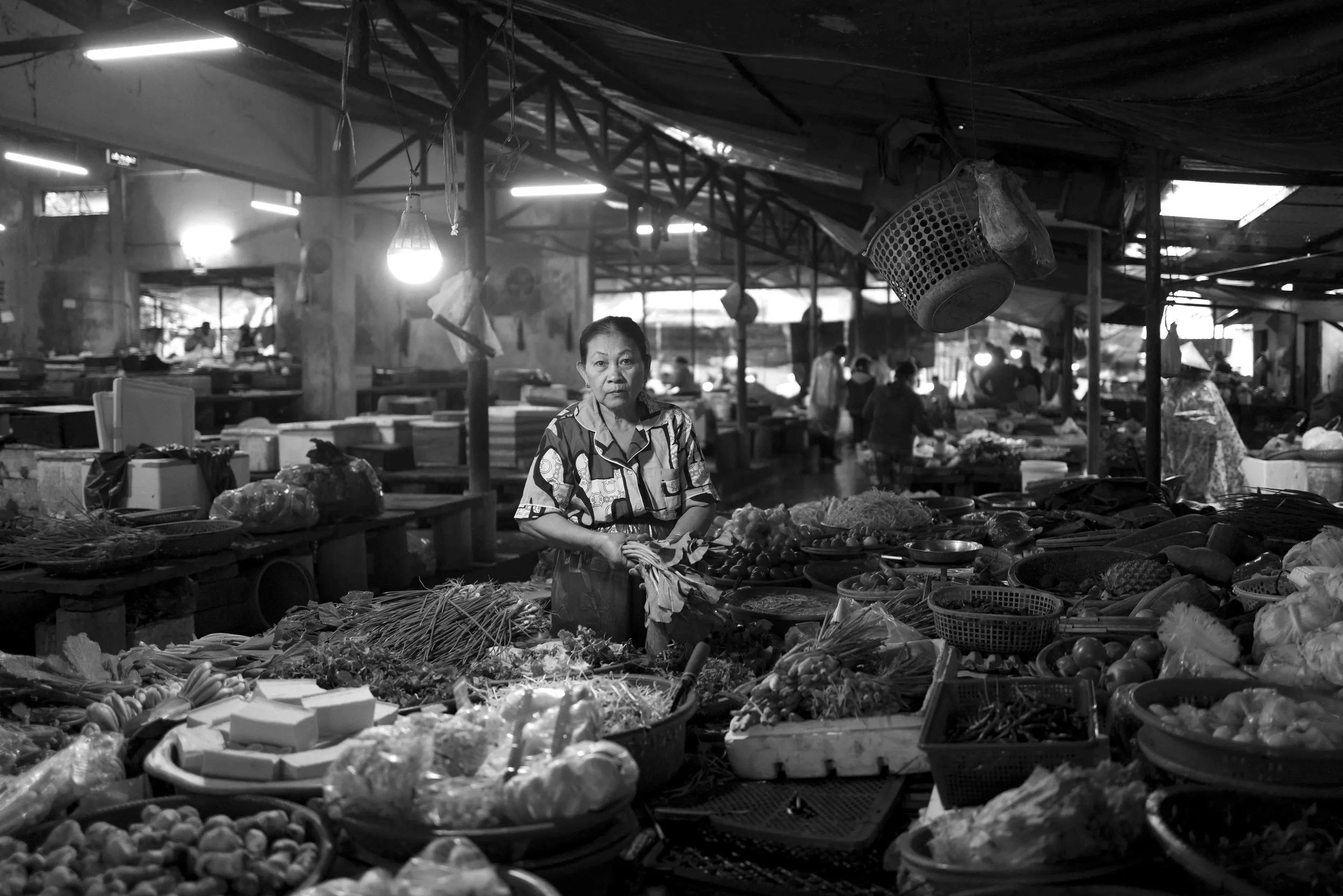 The food market in Hue was filled with fresh vegetables that make up the mainstay of the Vietnamese diet.  I took this photo because I was drawn to the beautiful light illuminating this hardworking vendor.