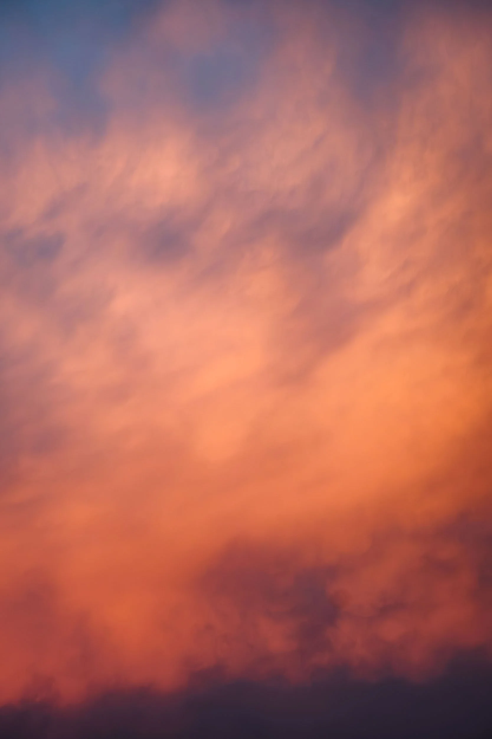 Colorful sunset sky with orange and purple clouds.