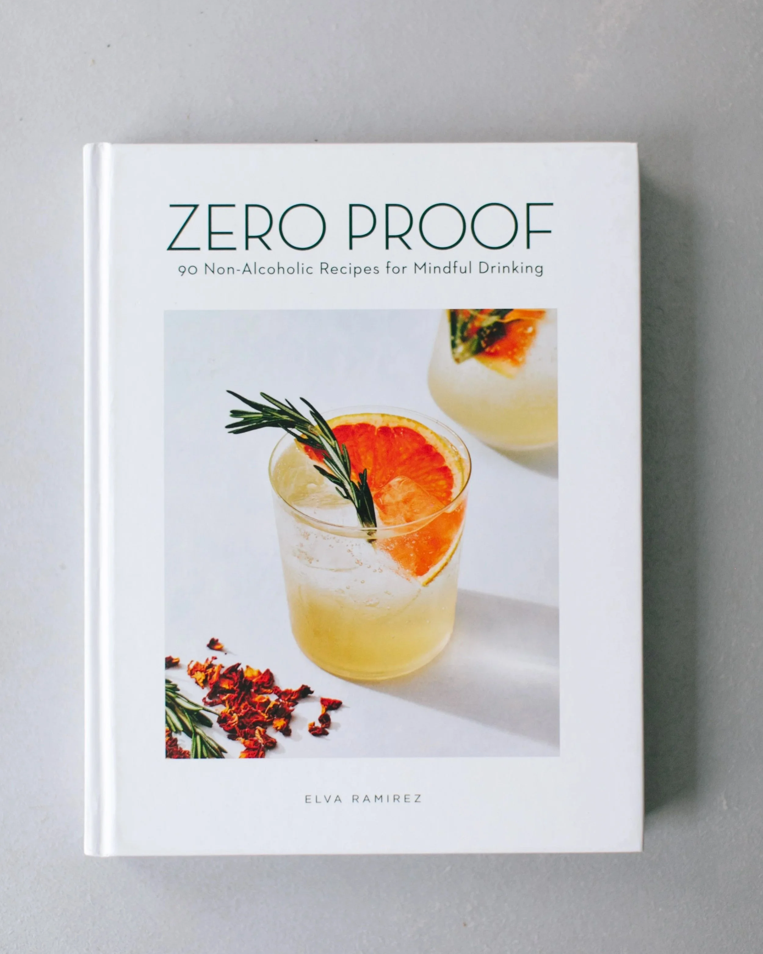 Zero Proof: 90 Non-Alcoholic Recipes for Mindful Drinking” by Elva Ramirez, a globally recognized book exploring the non-alcoholic cocktail movement. Mixologist David Paz is mentioned, highlighting his presence within contemporary mixology.