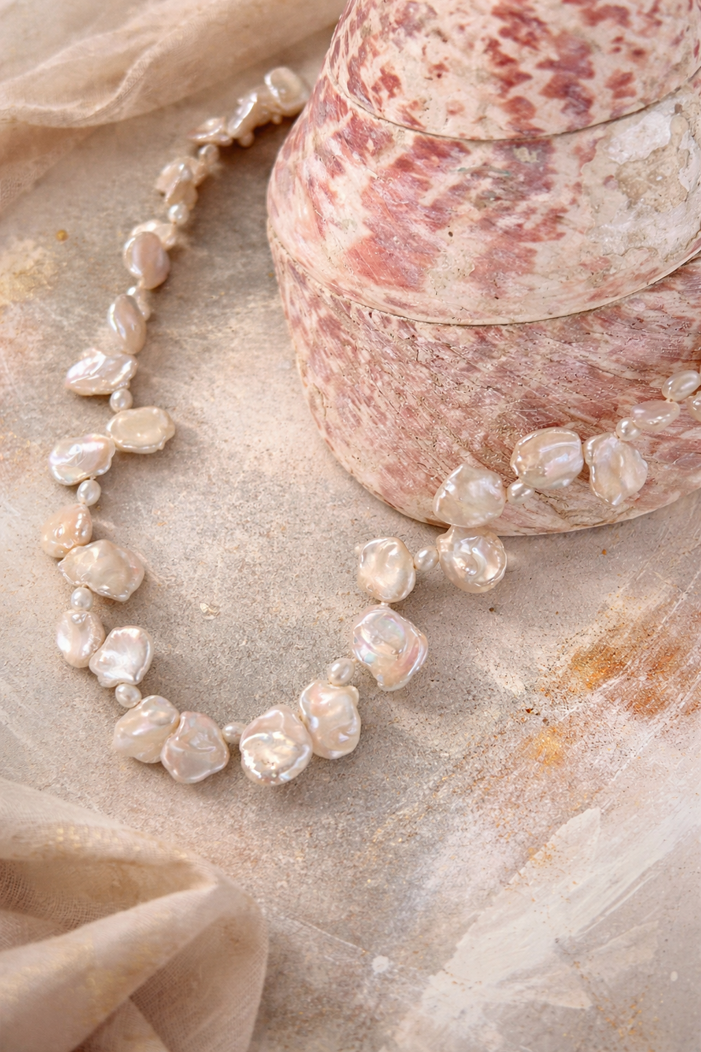 Elegant keshi pearls and seashell detail.png