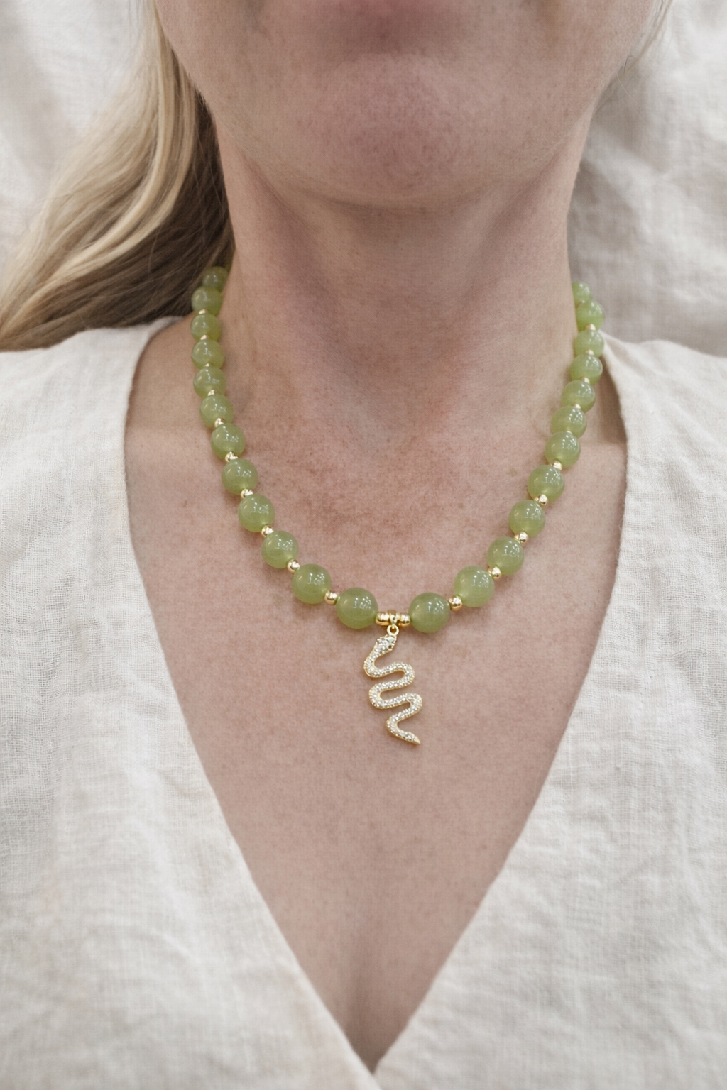 Jade necklace with gold snake pendant.png