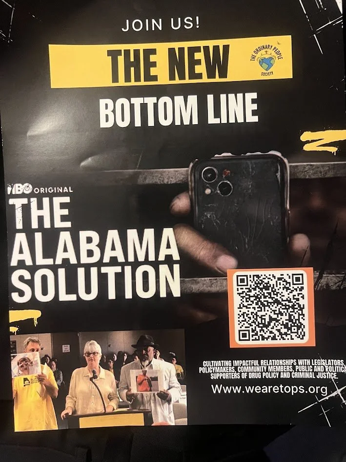 Flyer promoting activism with the headline "Join Us! The New Bottom Line - The Alabama Solution" and a logo for The Ordinary People Society. It features a hand holding a phone with a cracked screen, a QR code, and a photo of people protesting.