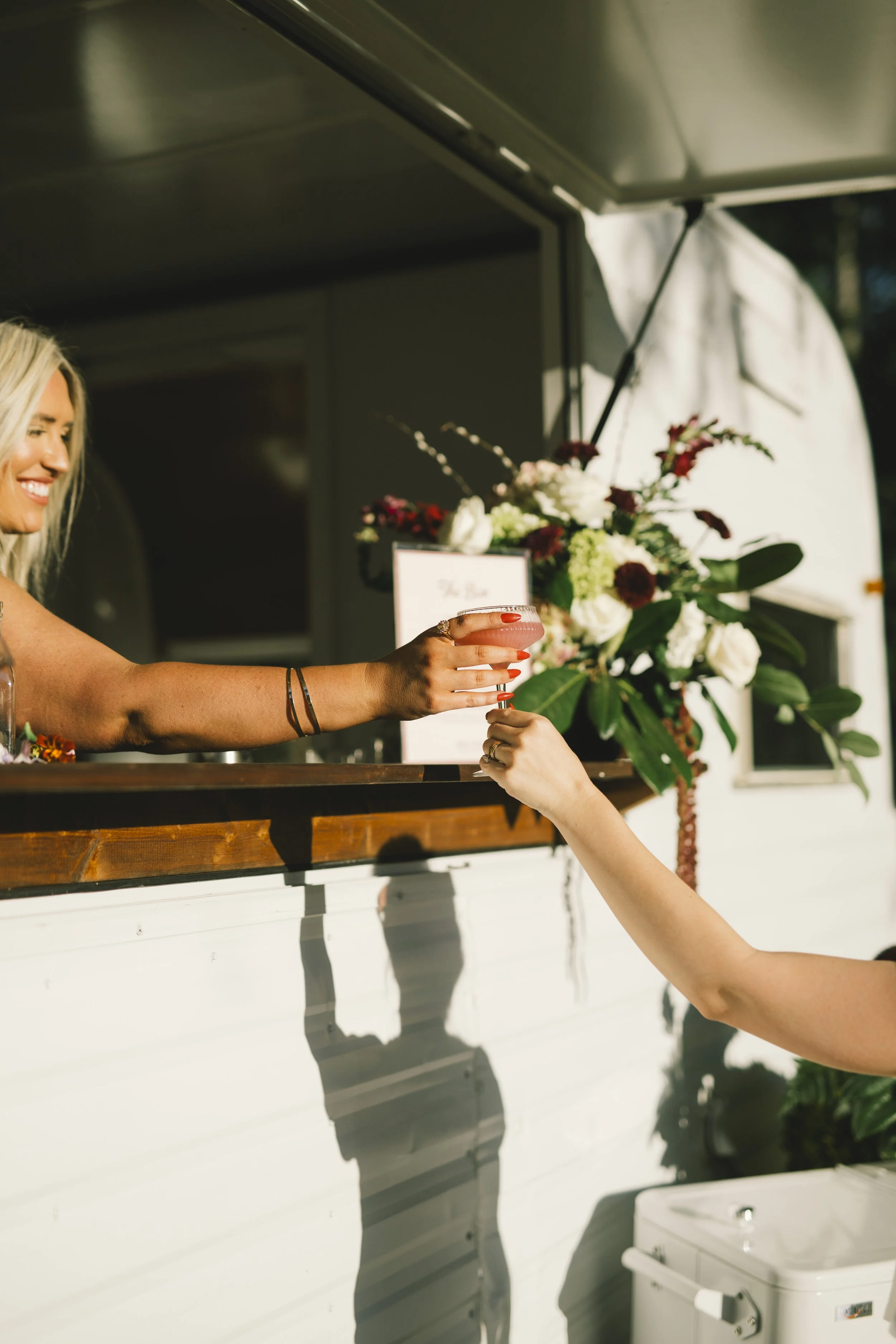 Event guest being handed a custom cocktail by a bartender from The Social Hour, serving the state of South Carolina, based in Aiken SC