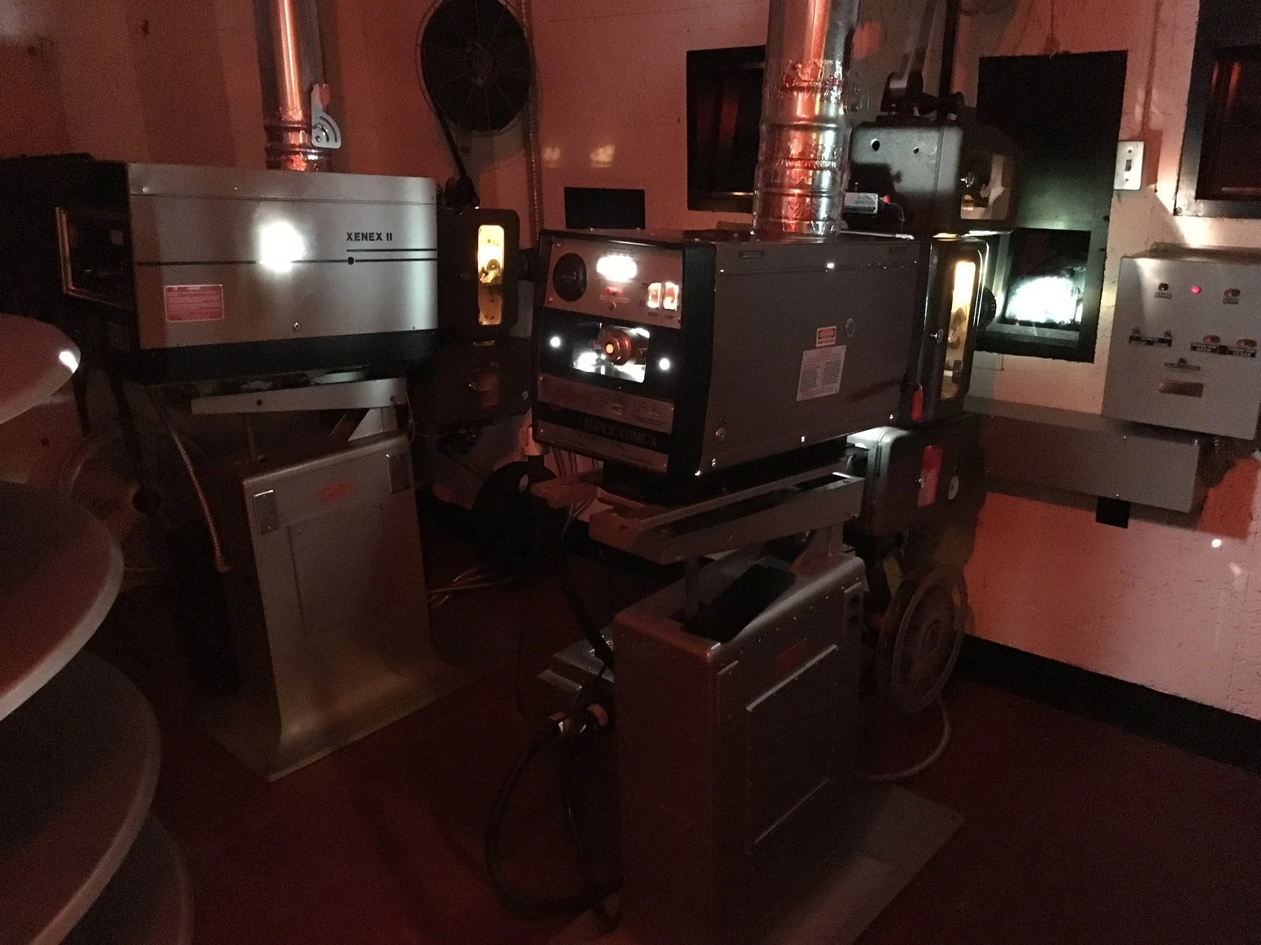 Medical or laboratory equipment with various machines and displays in a dimly lit room.