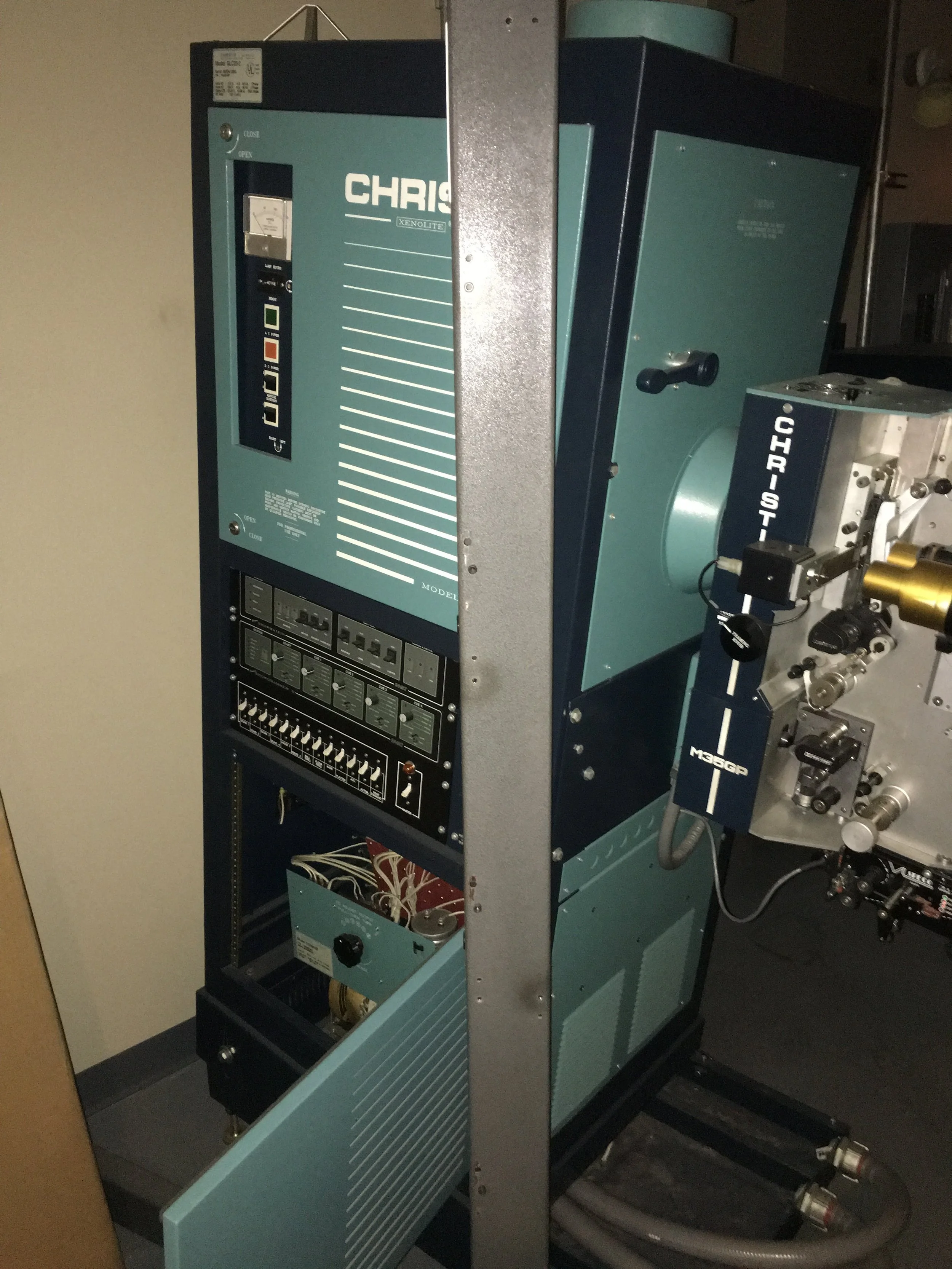 Close-up of a scientific or industrial machine with control panels, switches, and connectors.