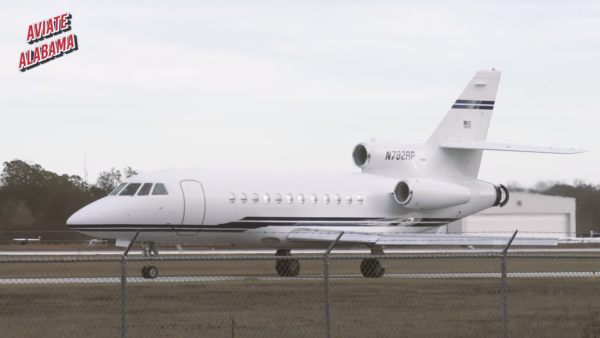 Private jet on the runway at an airport, with the text "Aviate Alabama" in the top left corner.