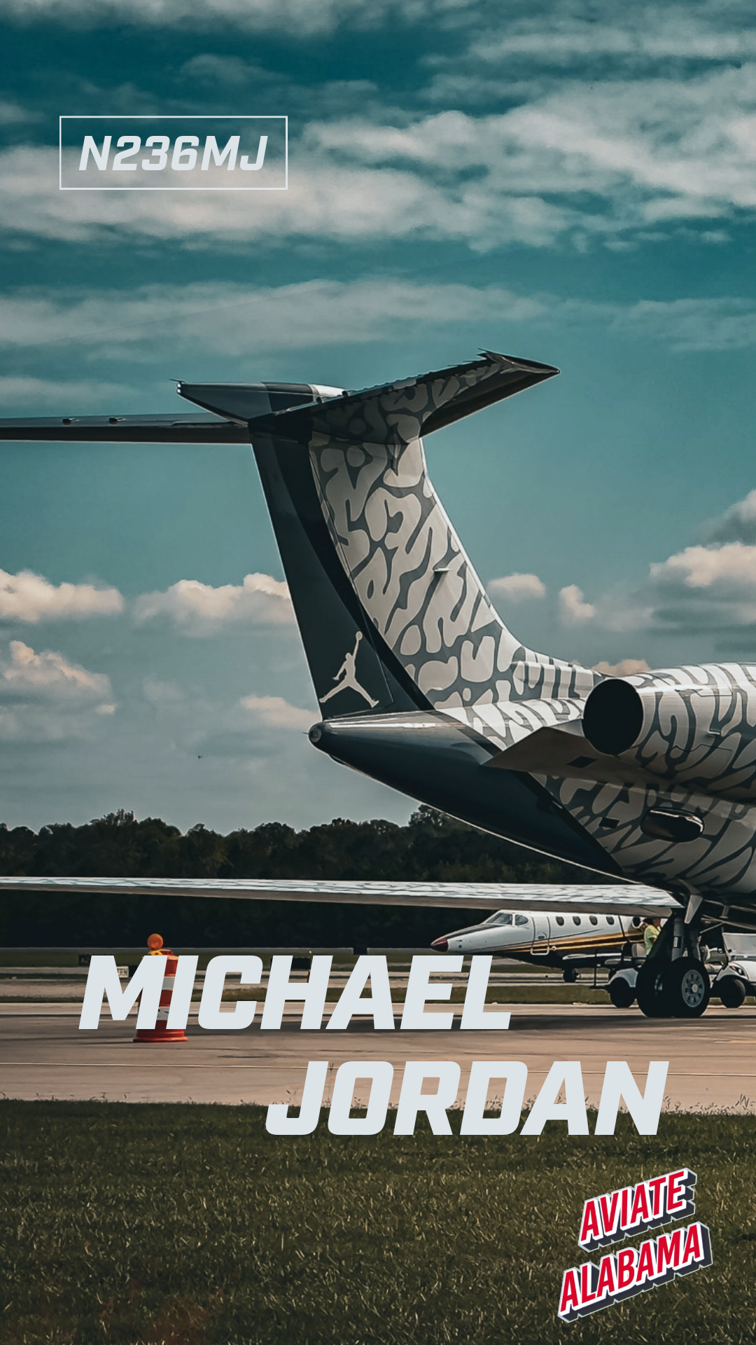 Private jet on an airport runway with the tail fin visible, decorated with a gray and black patterned design and the Jordan brand logo. Text overlay includes the name 'Michael Jordan' and details 'N236MJ', with a label 'Aviate Alabama' at the bottom right.