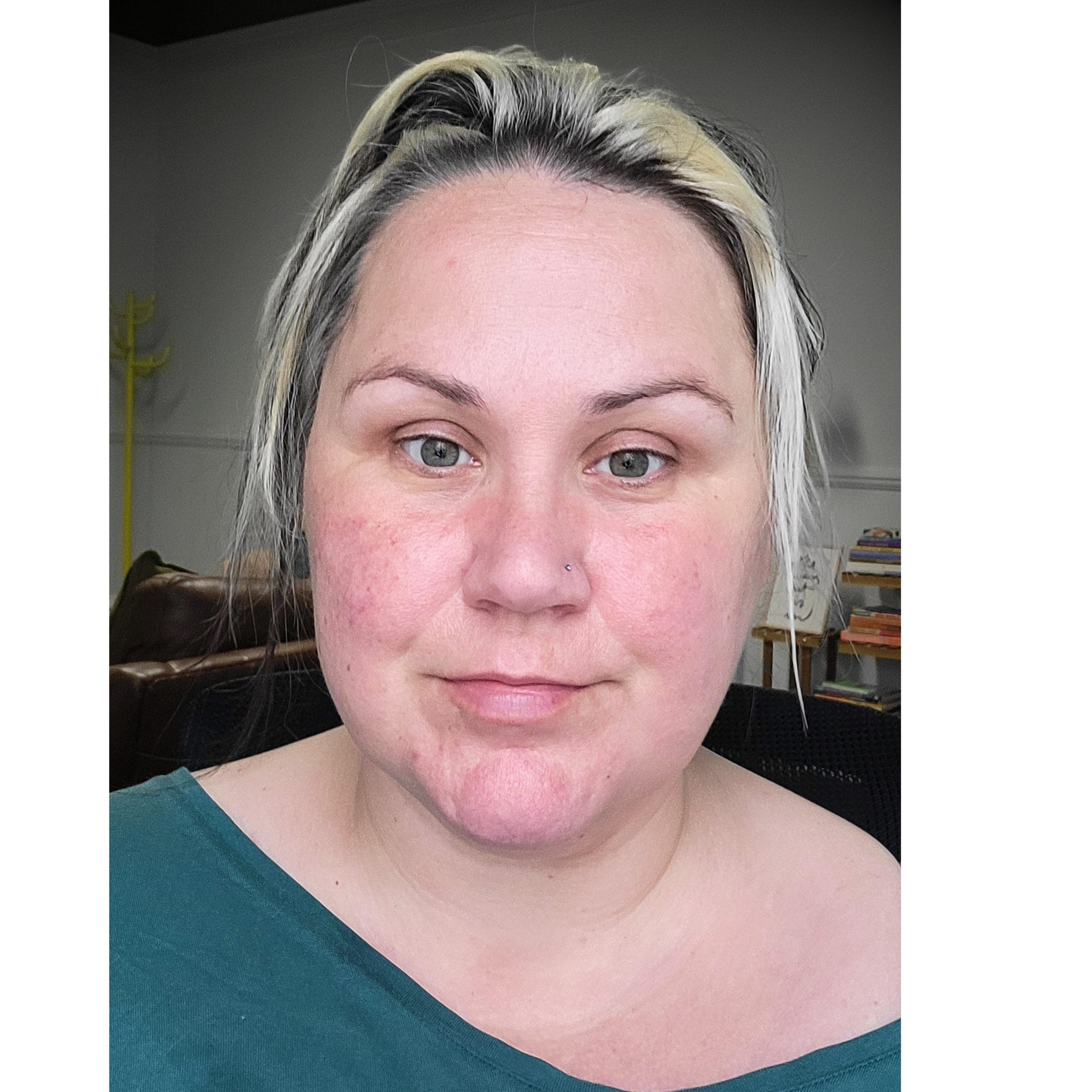 Close-up of a woman's face showing her eyes, forehead, and part of her nose, with her hair styled with blonde highlights and a natural complexion.