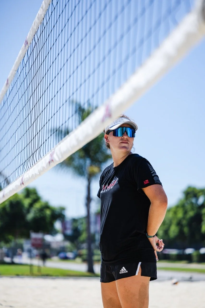 Coach Jacinda Ramirez standing at the net