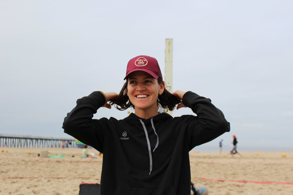 Coach Angela “Benny” White smiling on the beach