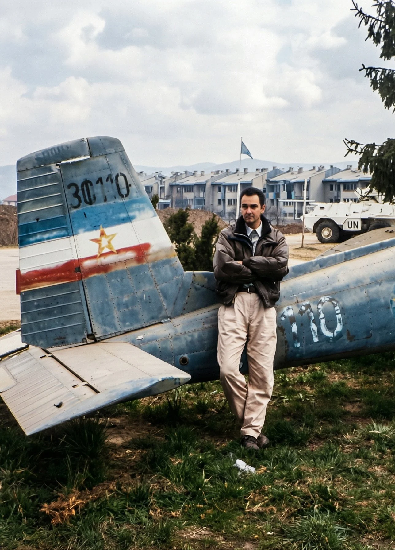 Adriatic & Balkan tour guide, standing beside an aircraft, in the city of Sarajevo, during the siege.
