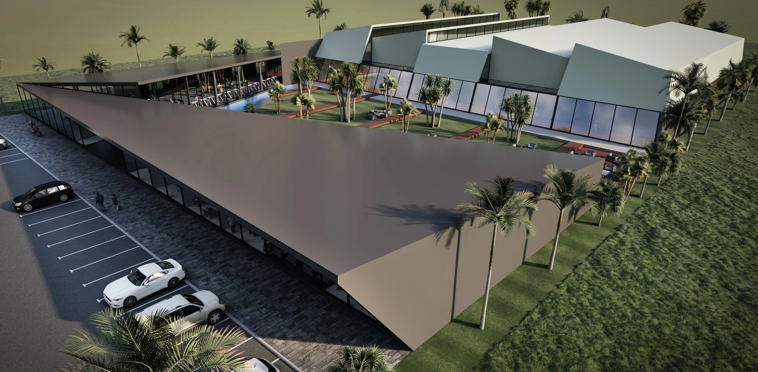 A modern building with a rooftop patio featuring palm trees and outdoor seating, surrounded by landscaped green areas and parking spaces.