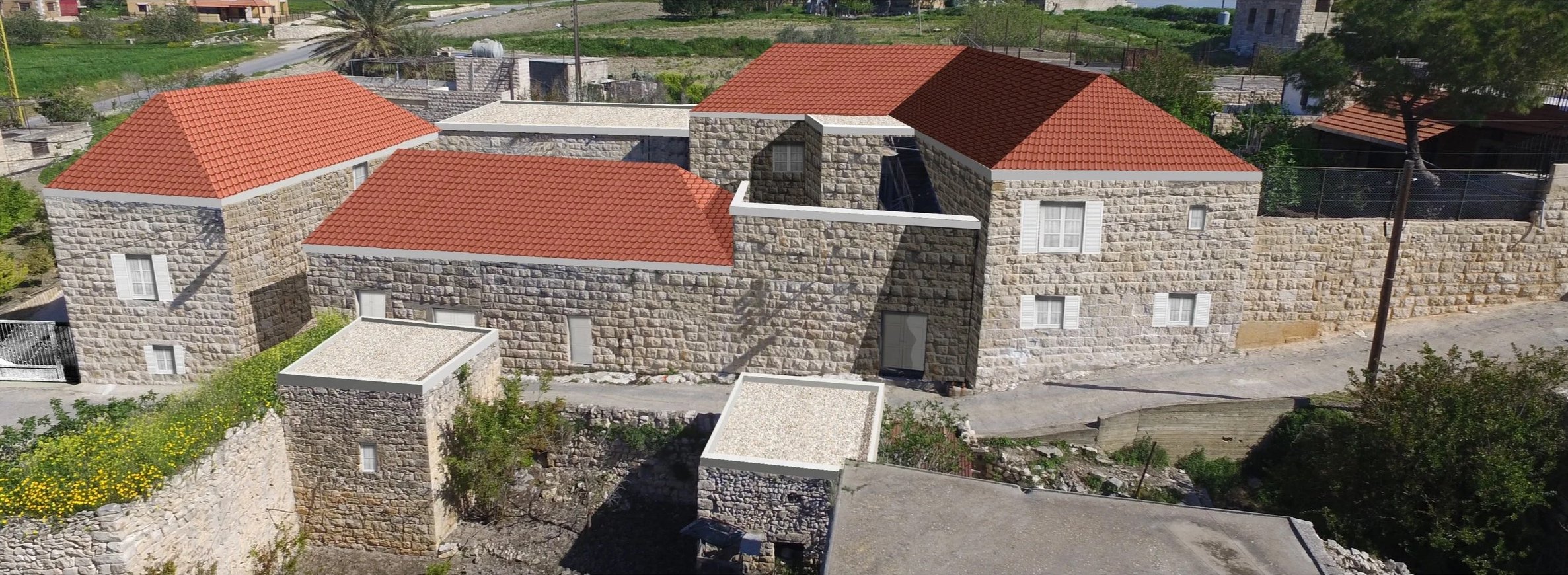 A proposed architectural design for Derdhaya Village featuring stone buildings with red roof tiles.