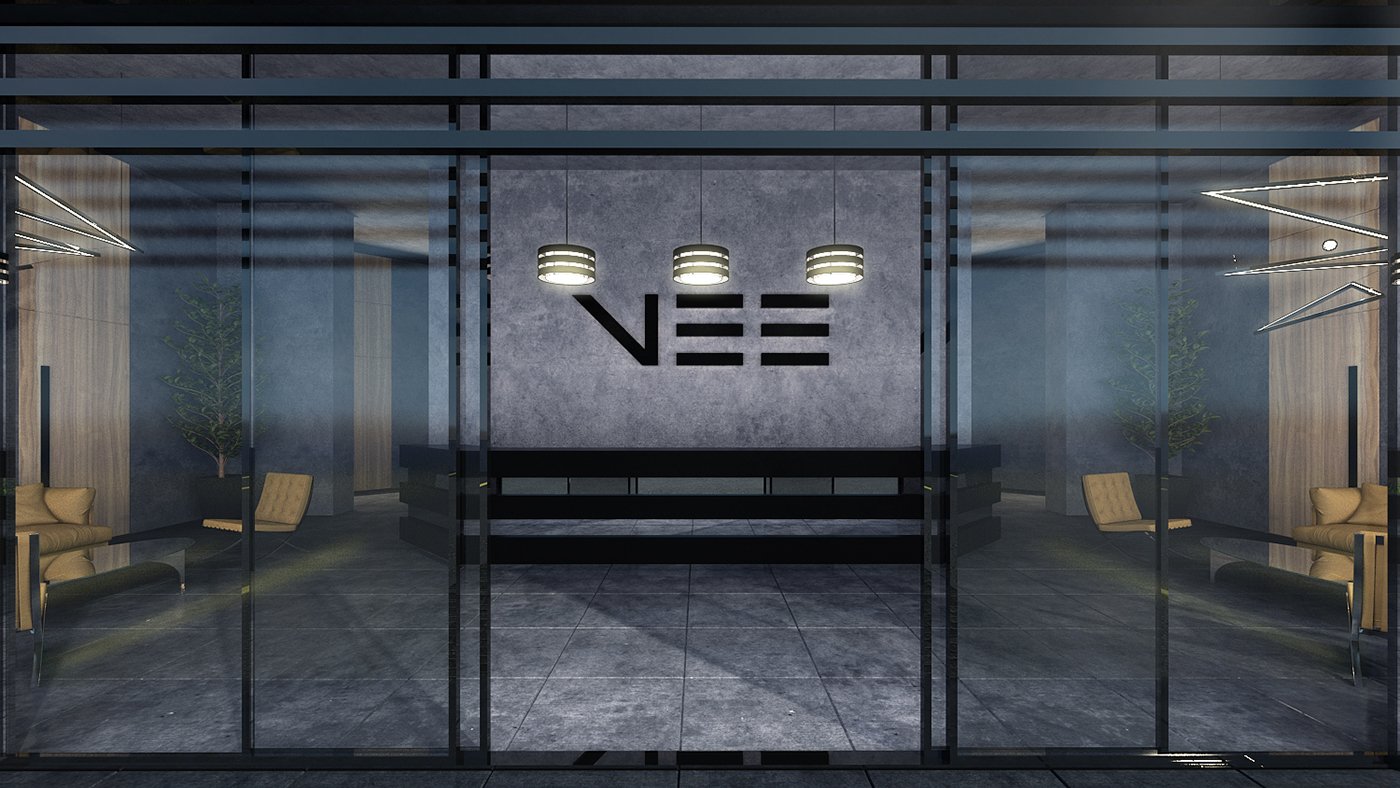 Modern lobby with glass doors, seating area with beige chairs, and a large wall with the word 'VEE' in black letters.