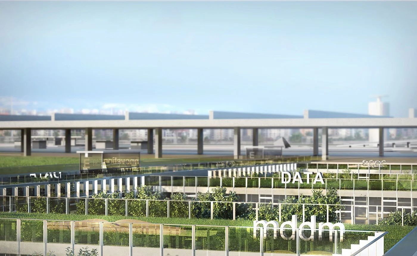 A modern rooftop garden with green plants, and white signs spelling 'DATA', 'mdm', and partly visible 'A0C'. In the background, a city skyline with various buildings and a sky with light clouds.