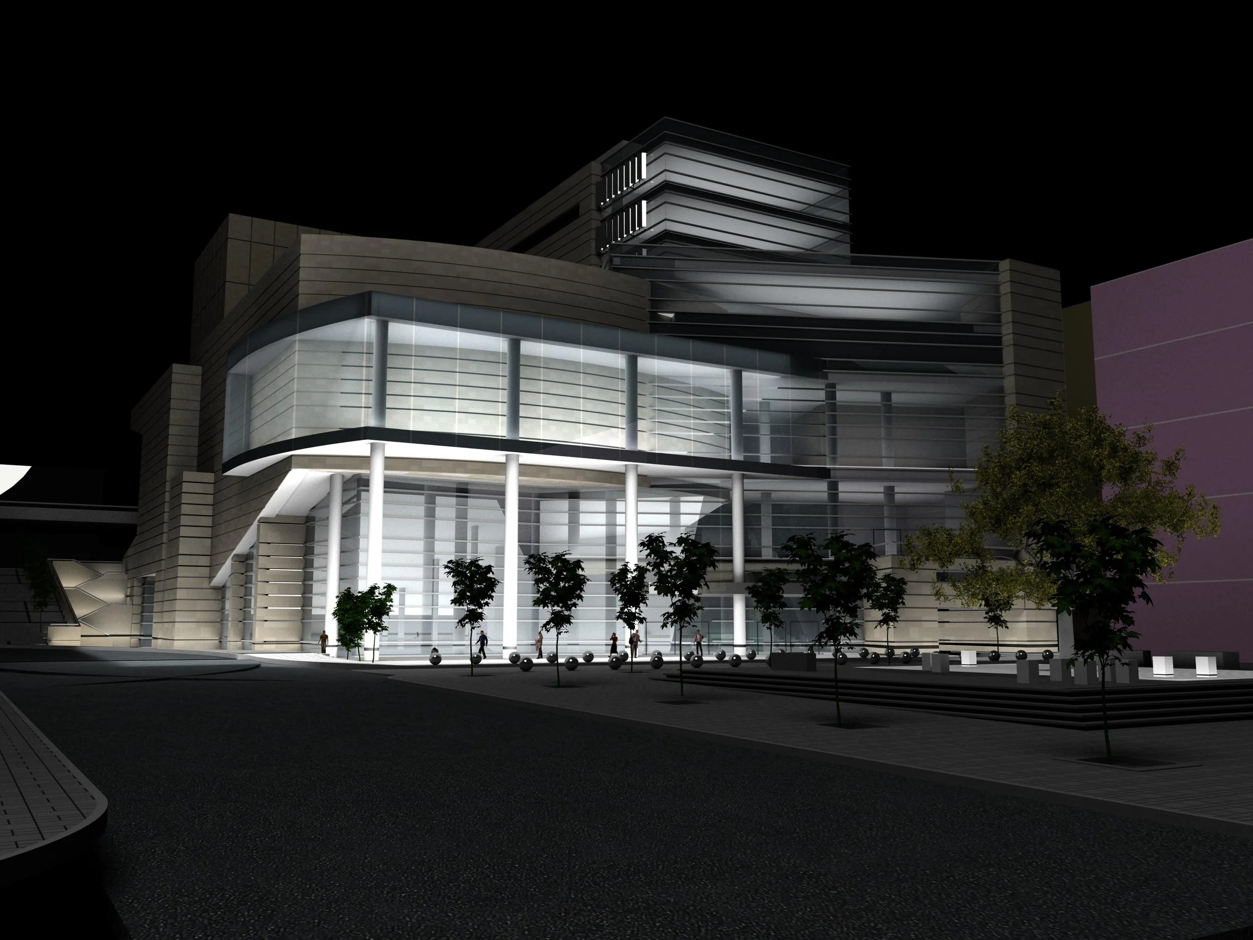 A modern architectural building with glass walls and illuminated interior, set against a dark night sky, with trees and a paved sidewalk in front.
