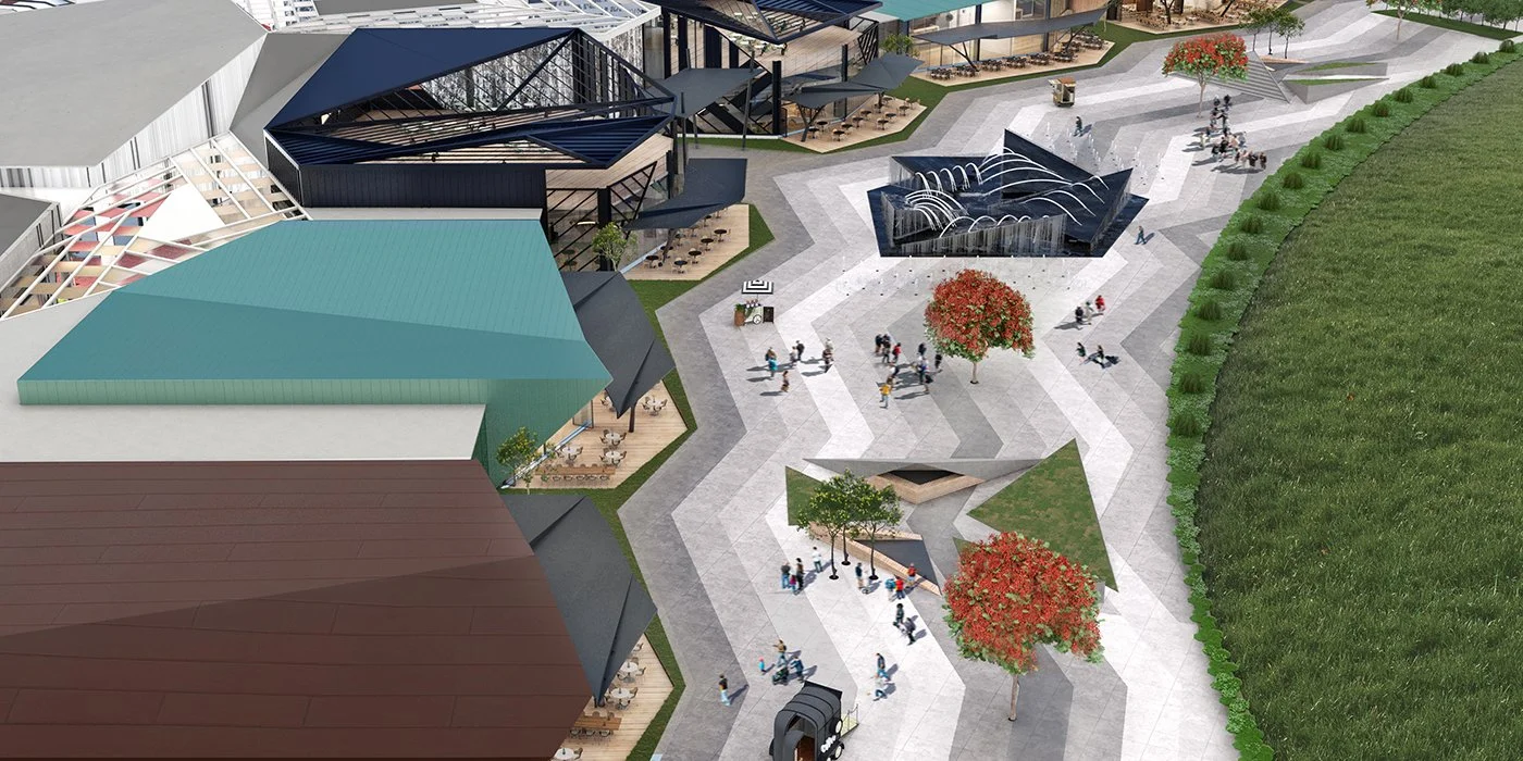 Aerial view of a modern outdoor shopping and dining area with various buildings, walkways, and trees with red leaves.