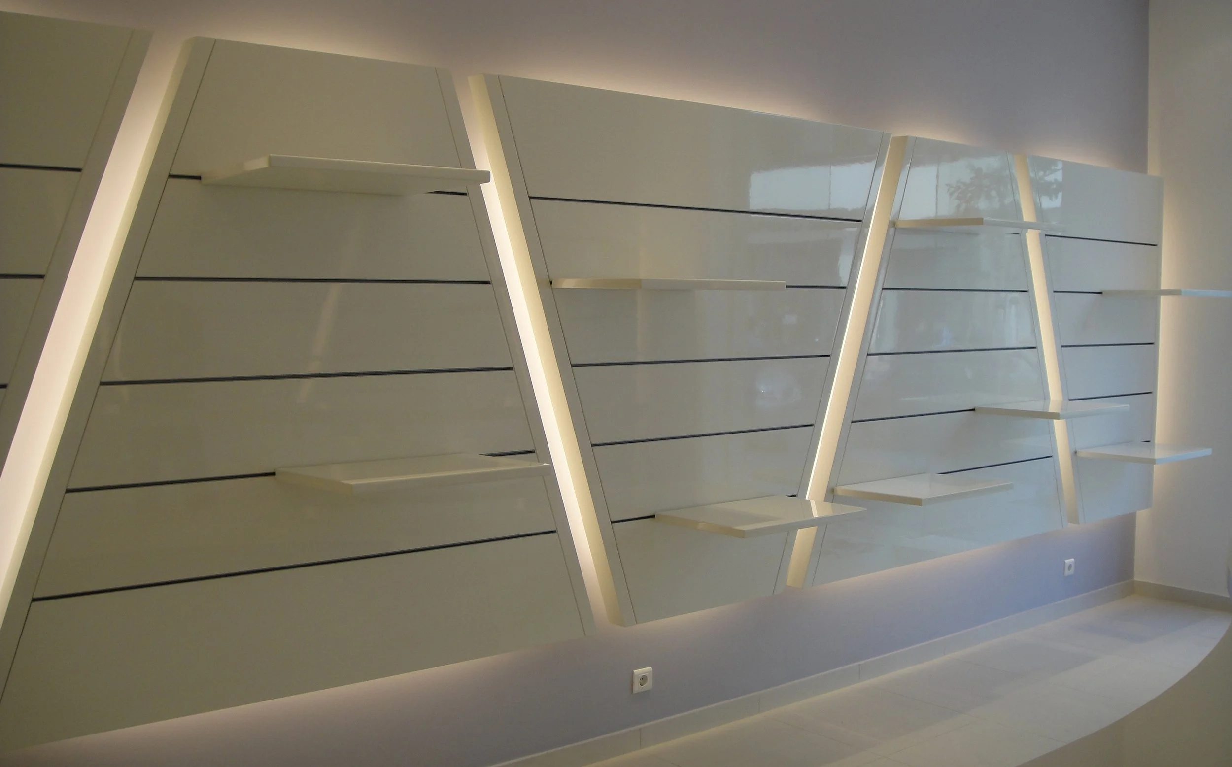 Modern interior space with illuminated white wall panels arranged in a geometric pattern.