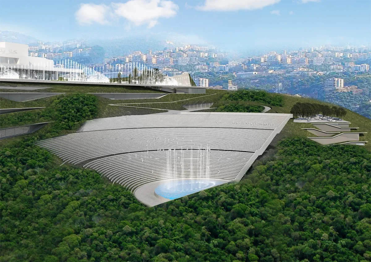 Rendering of a large, modern auditorium or amphitheater built into a hillside, with tiered seating surrounding a central stage or water feature, and a cityscape with numerous buildings in the background.