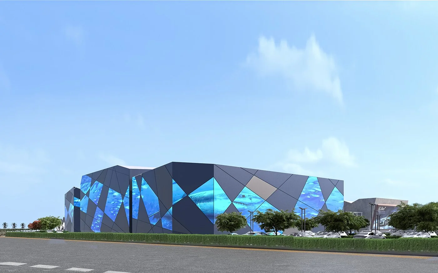 Modern building with a geometric facade featuring blue glass panels, nearby parking lot, trees, and a clear sky.